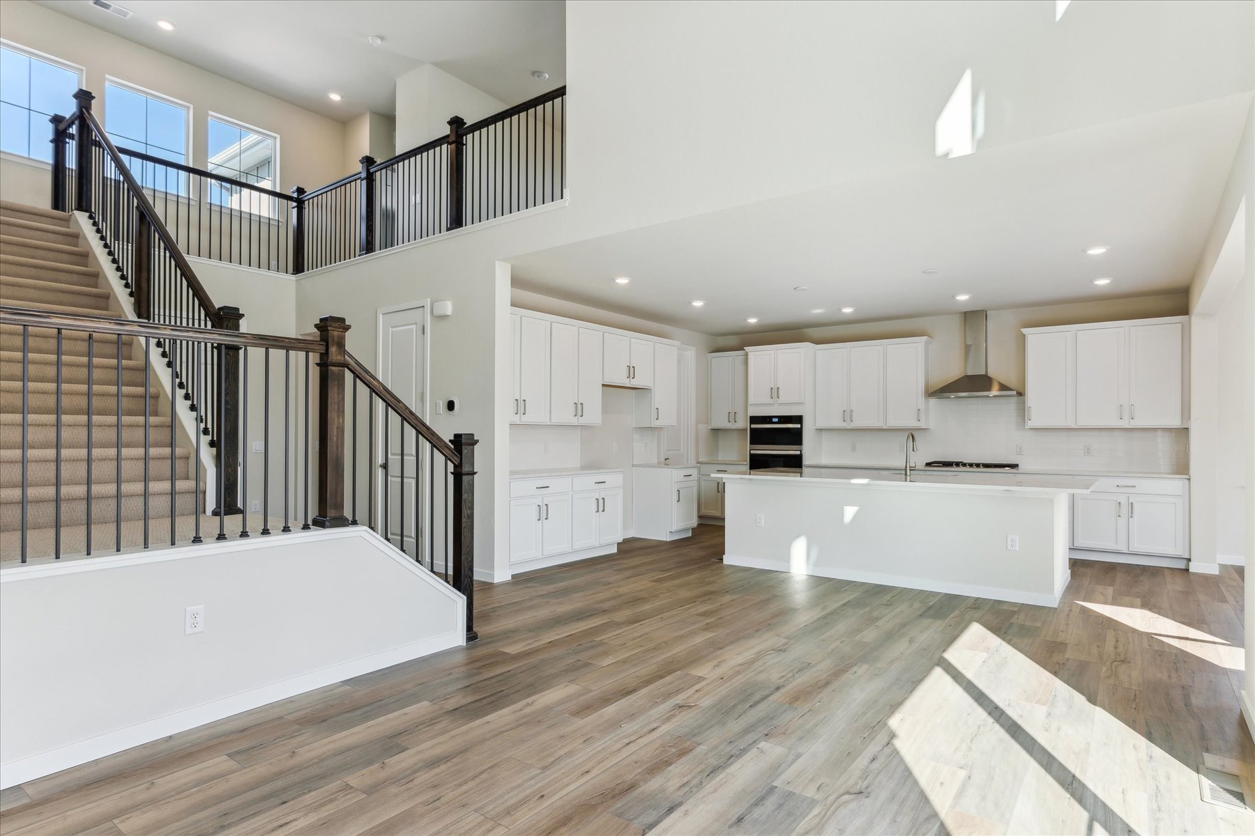 A large white kitchen with white cabinets.