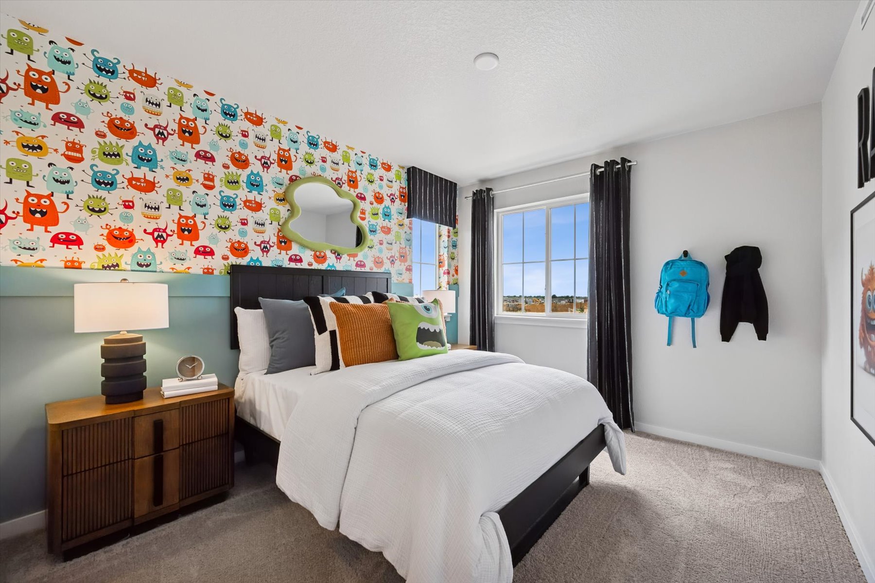 A bedroom with a bed and a lamp.