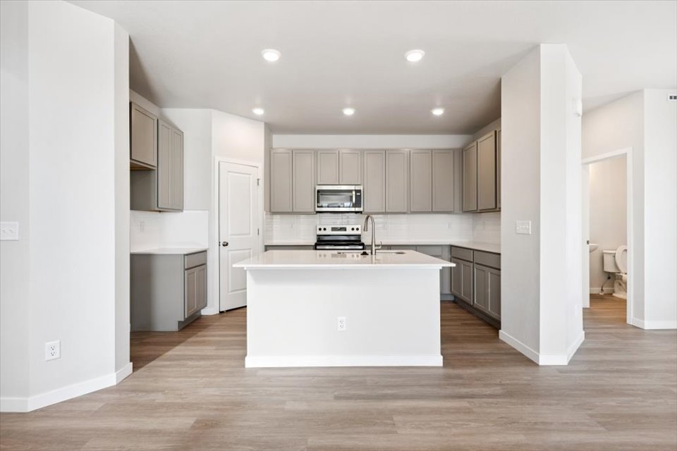A kitchen with white cabinets.