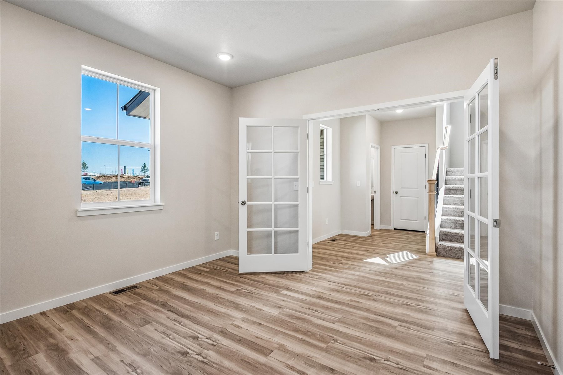A room with white walls and a wood floor.