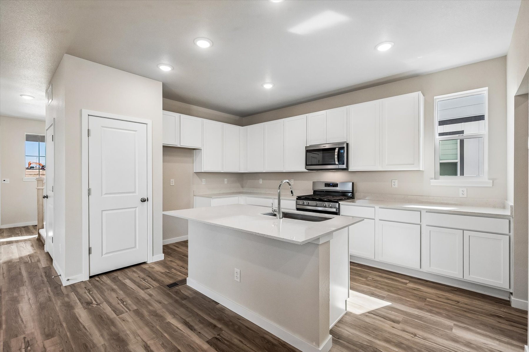 A kitchen with white cabinets.