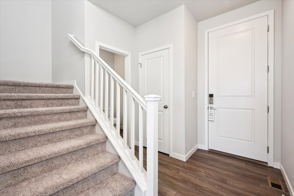 A staircase with white doors.