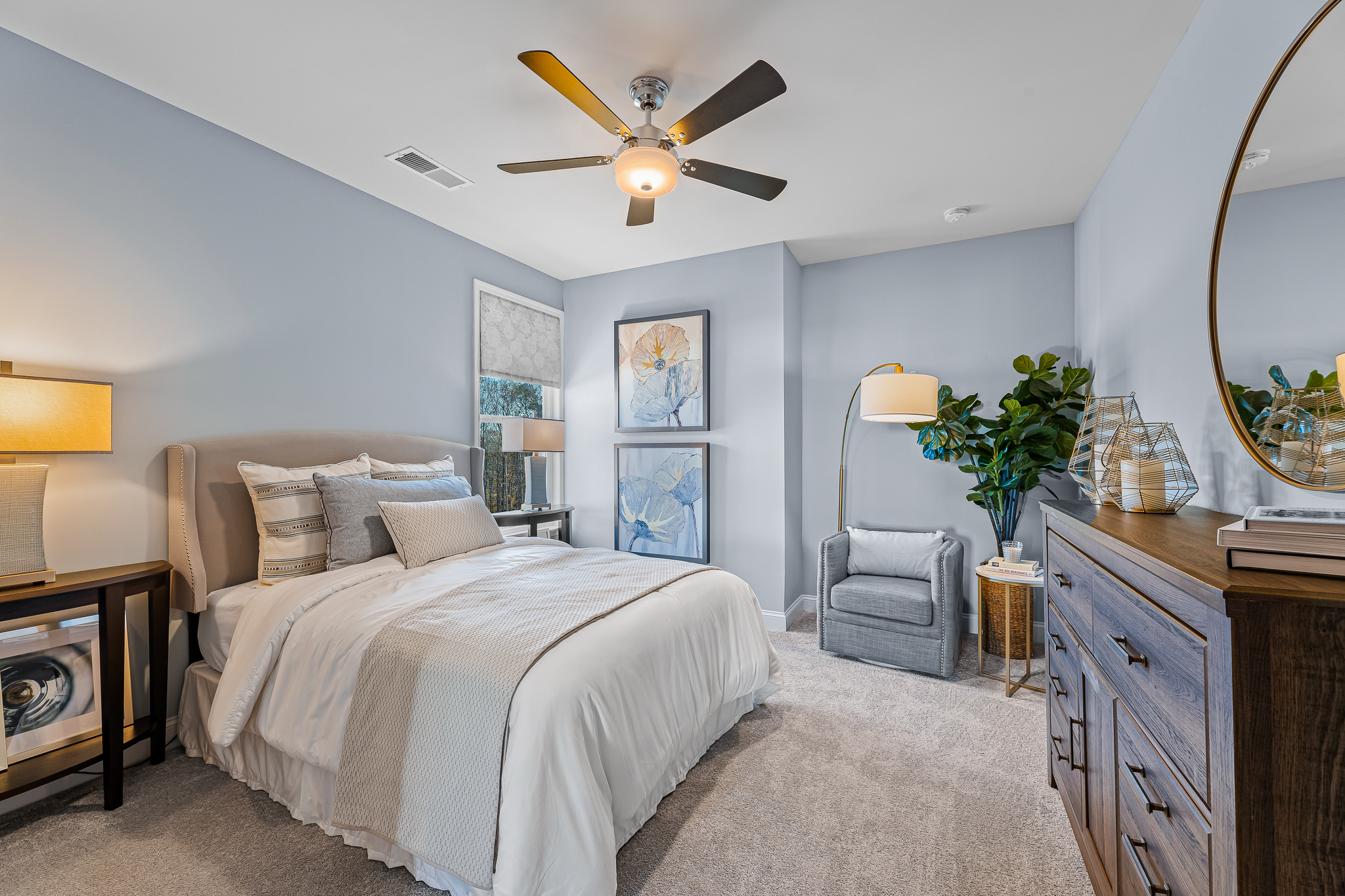 A bedroom with a bed and a fan.