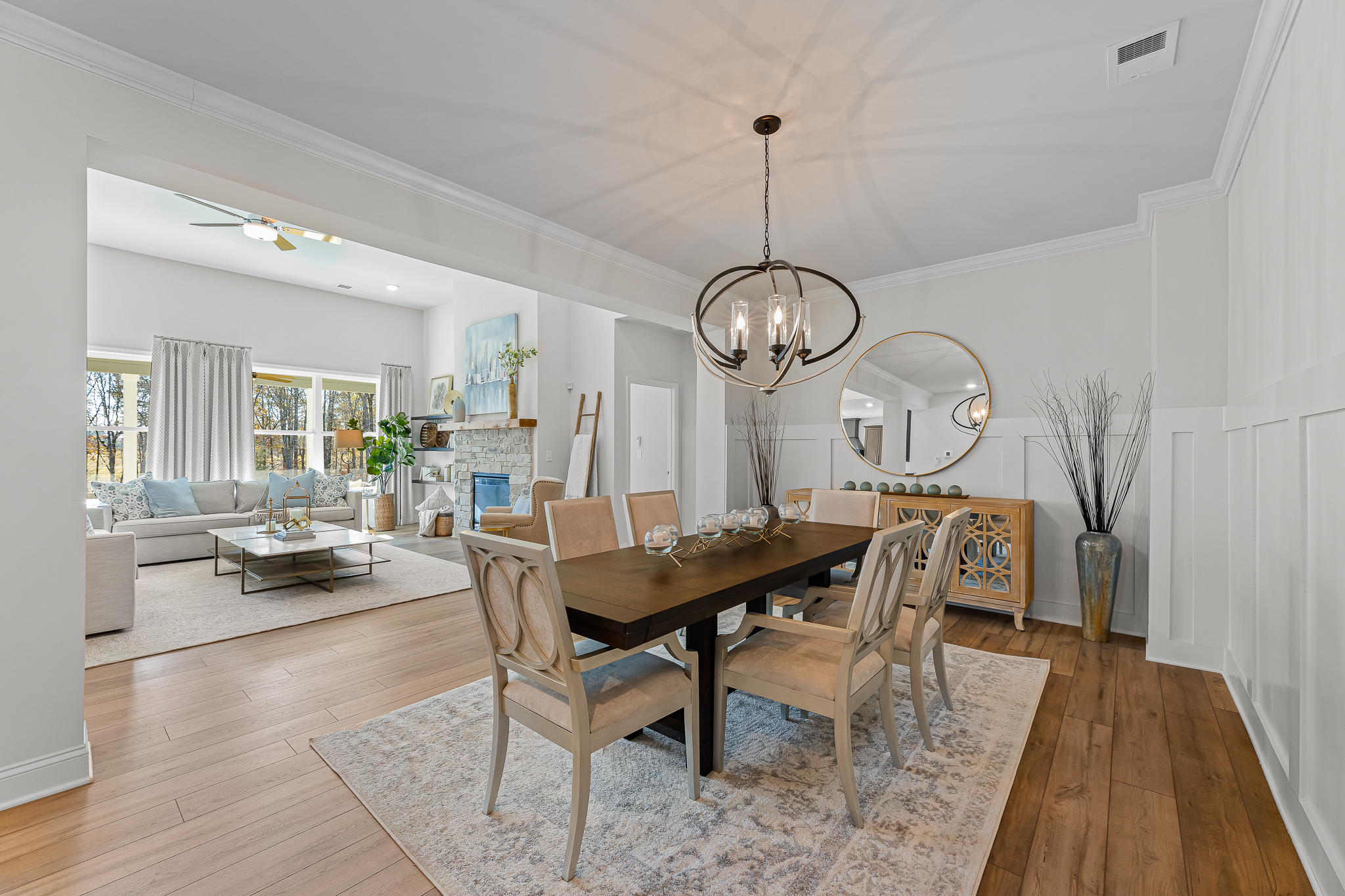 A dining room with a chandelier and a table.
