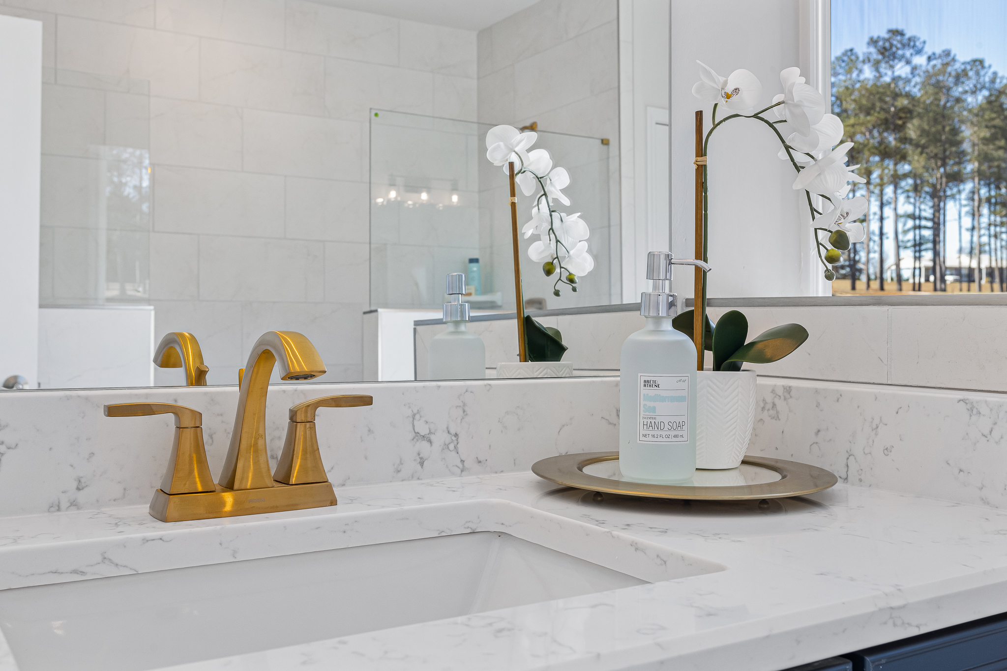 A bathroom with a sink and a mirror.