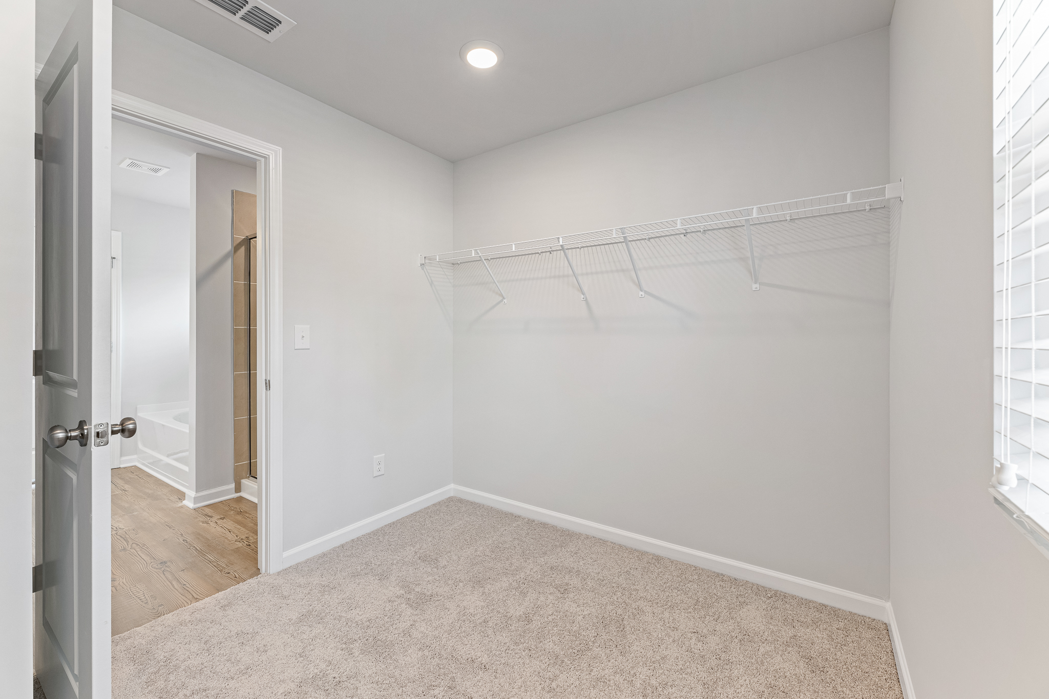 A room with a white wall and a door.