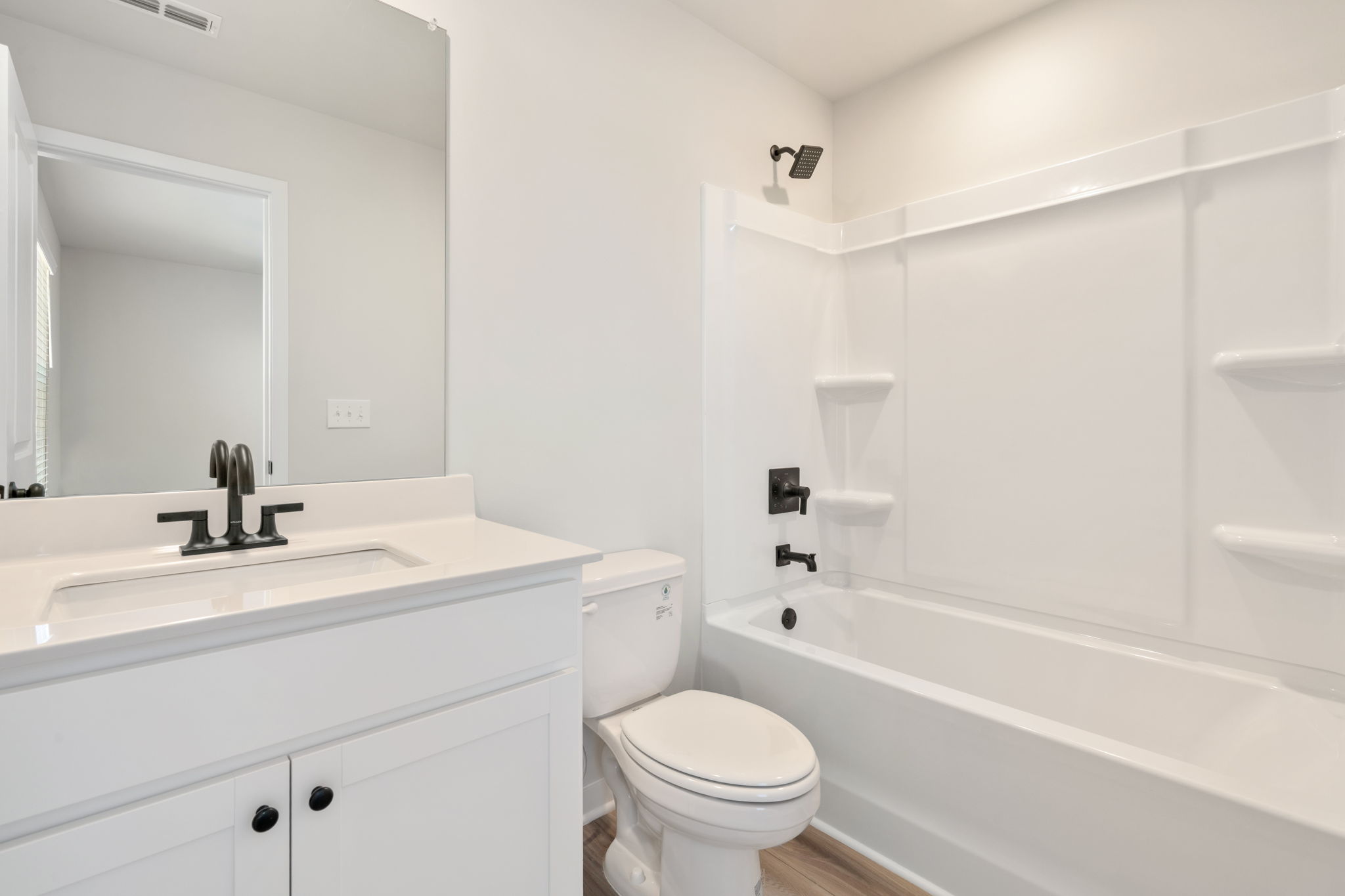 A bathroom with a tub sink and toilet.