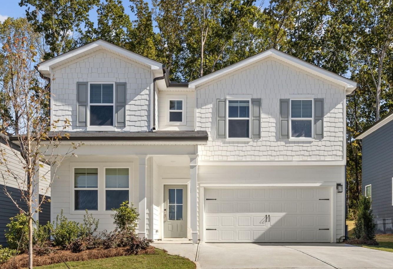 A white house with a garage.