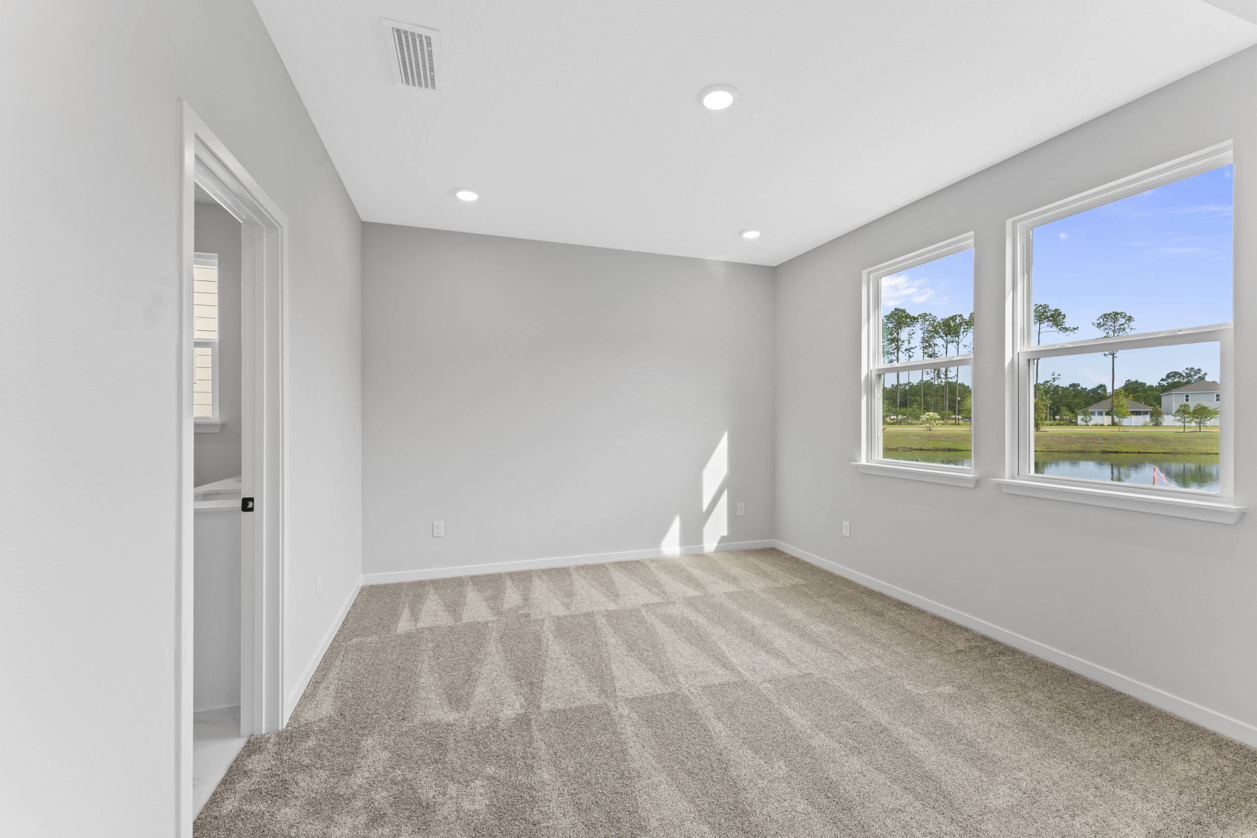 Miramar Floorplan Lot 81 Primary Bedroom with Large Windows at Concourse Crossing in Fernandina Beach