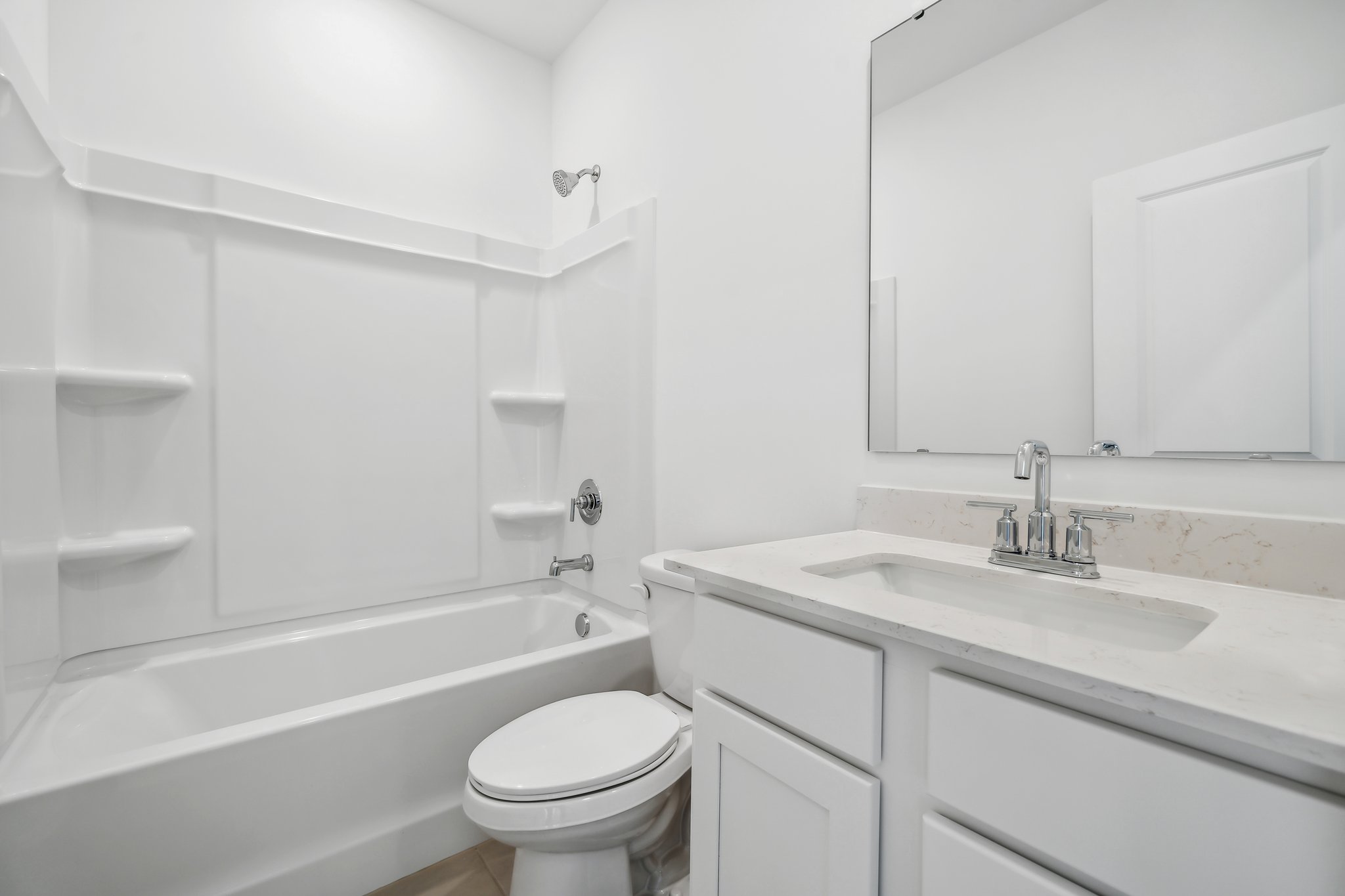 A bathroom with a tub sink and toilet.