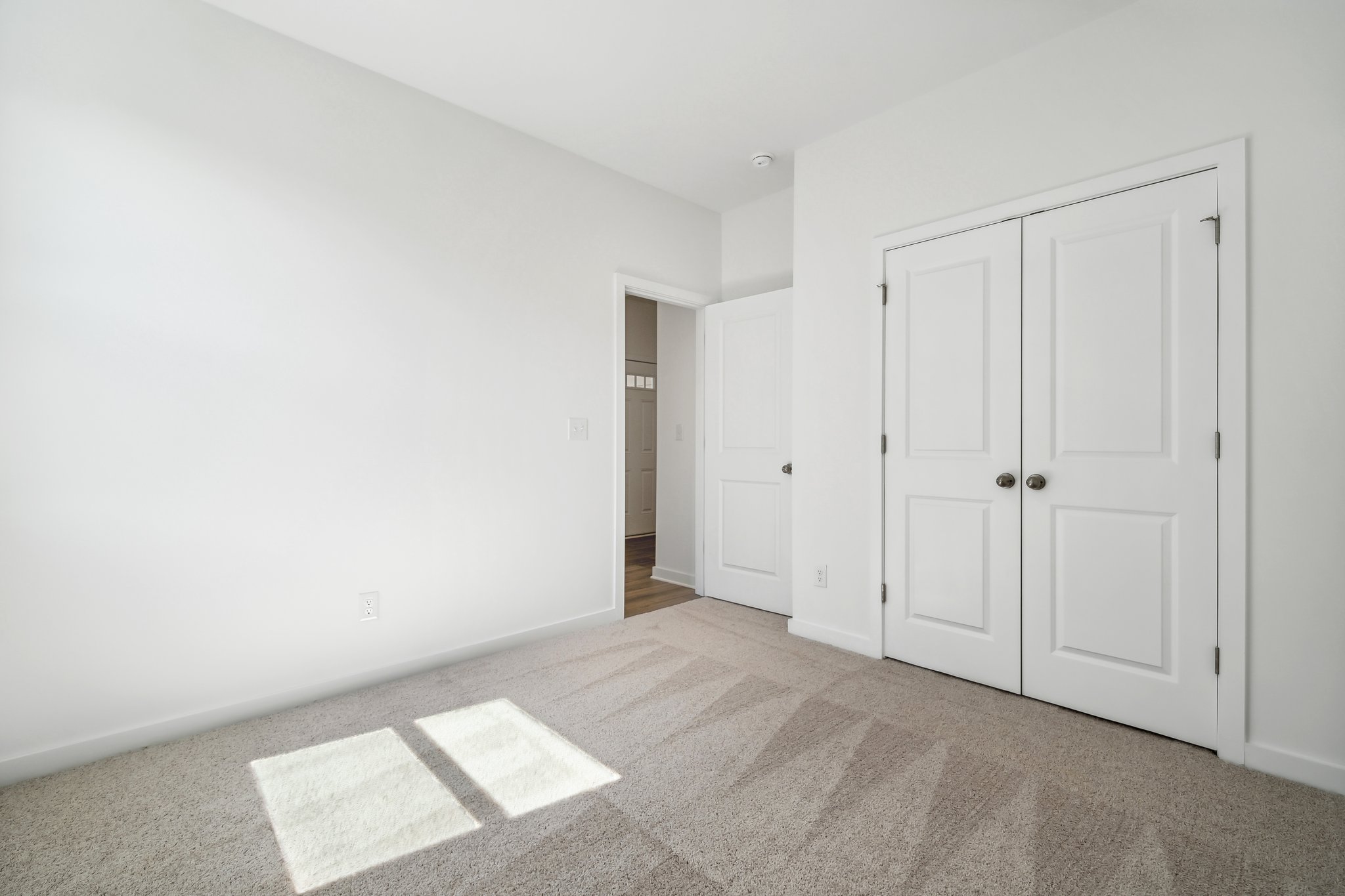 A hallway with white doors.
