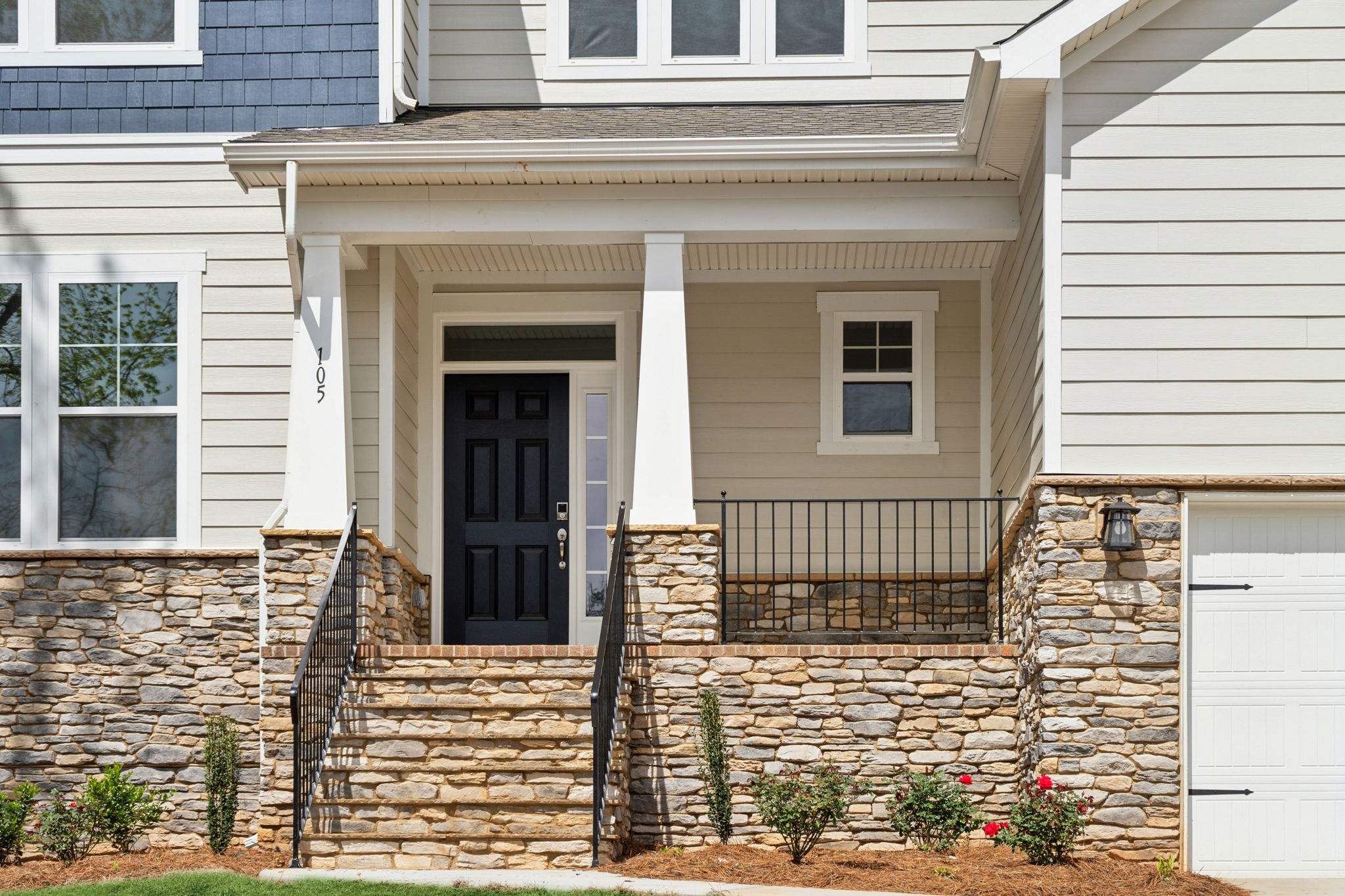 A house with a stone wall and a gate.