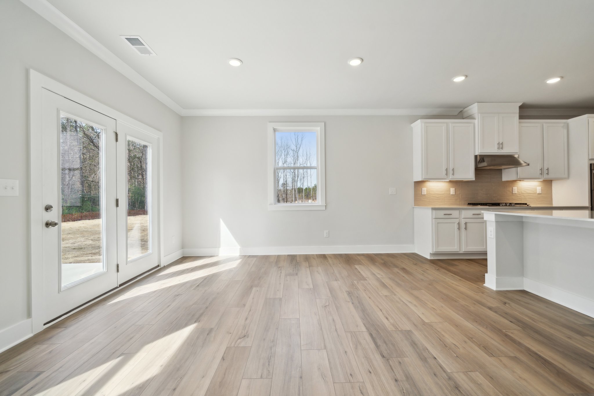 A kitchen with white cabinets.
