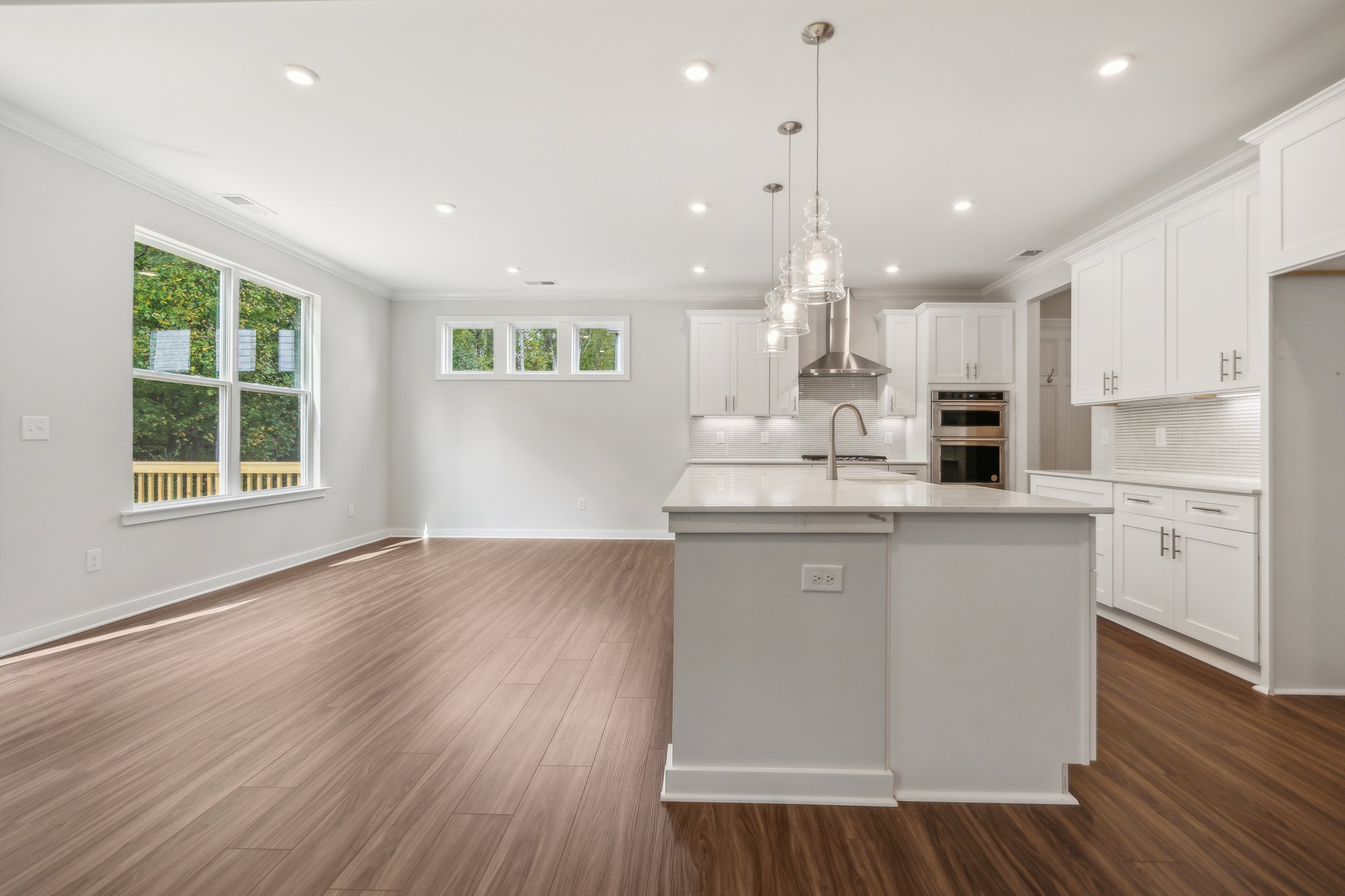 A large kitchen with white cabinets.