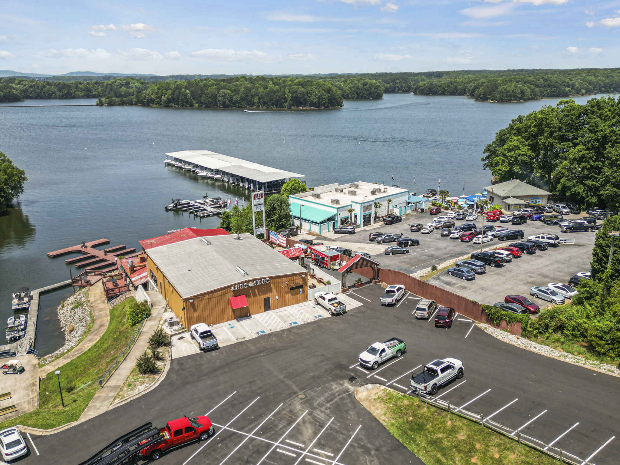 A parking lot next to a body of water.