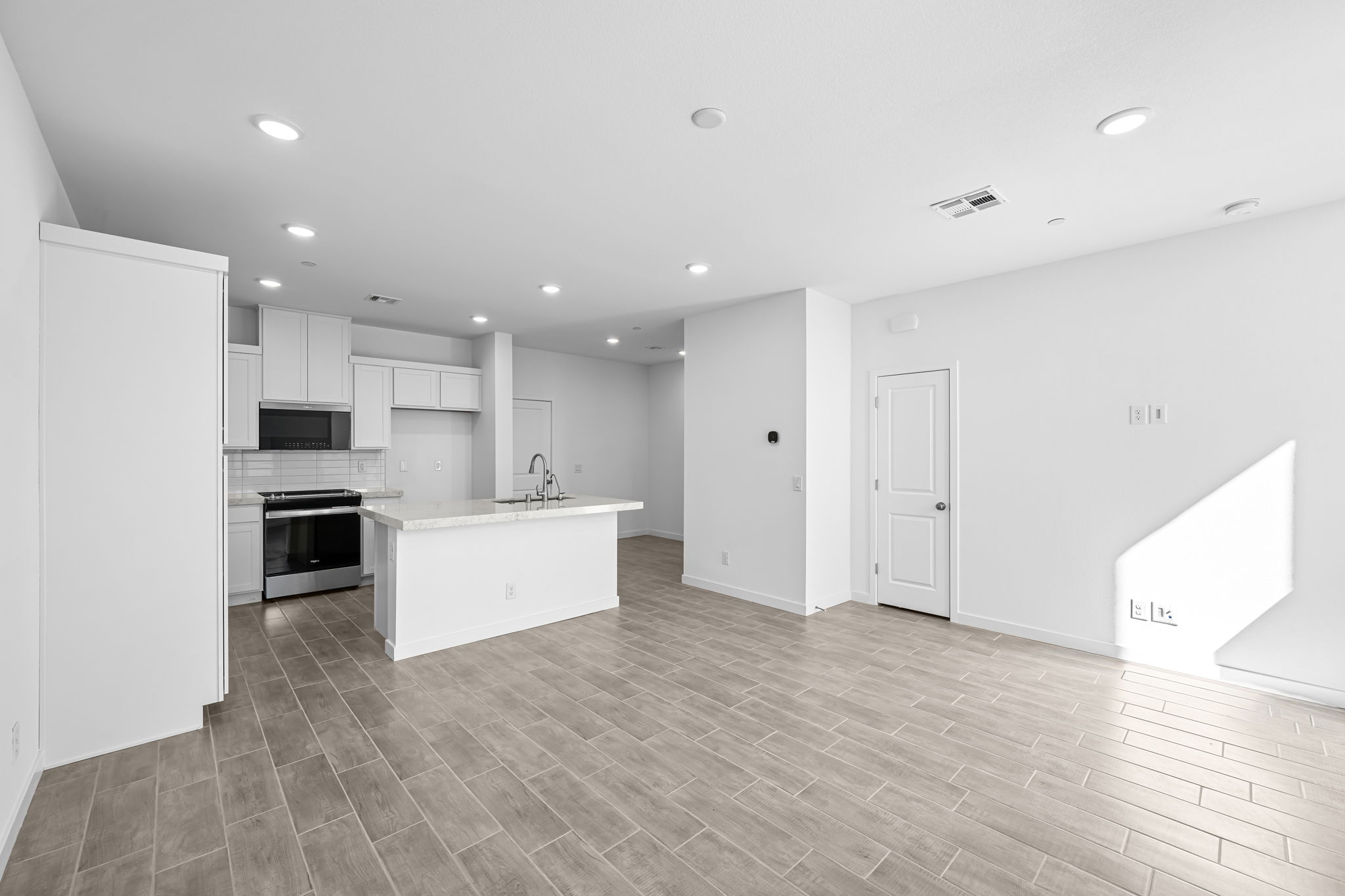 A kitchen with white cabinets.
