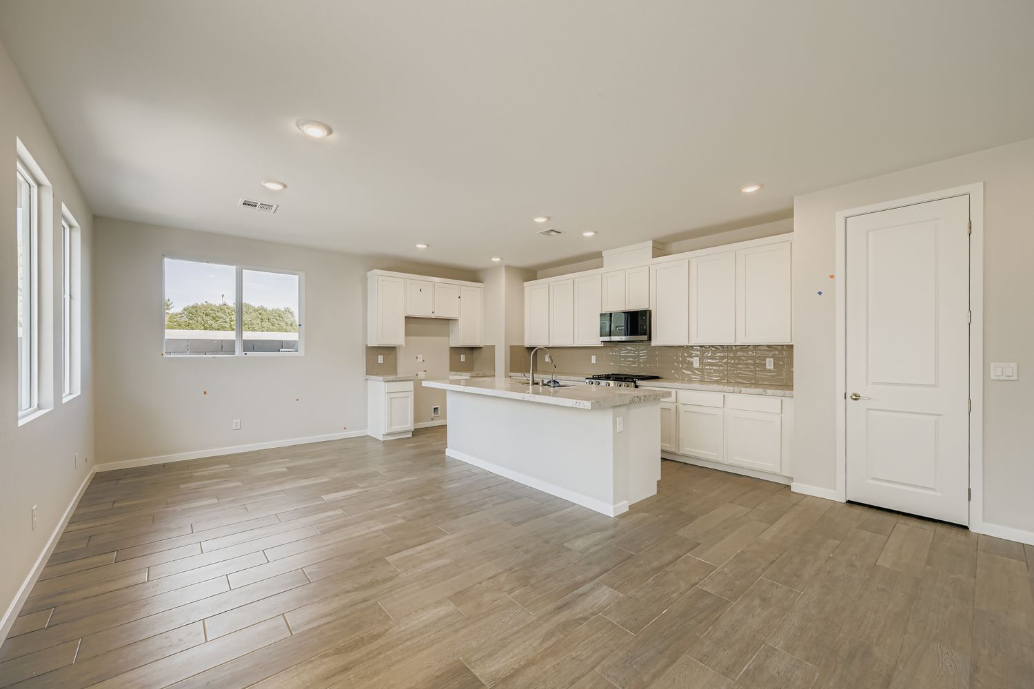 A large kitchen with white cabinets.