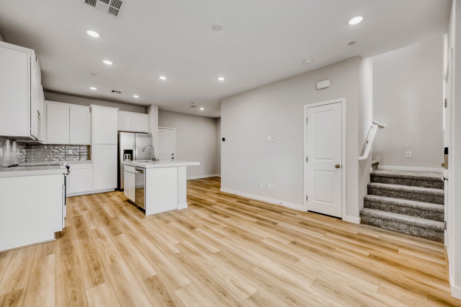 A kitchen with white cabinets.