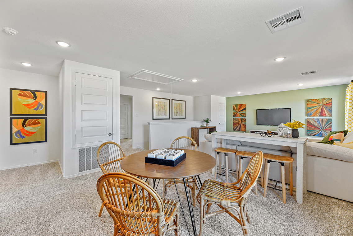 A room with a table and chairs.