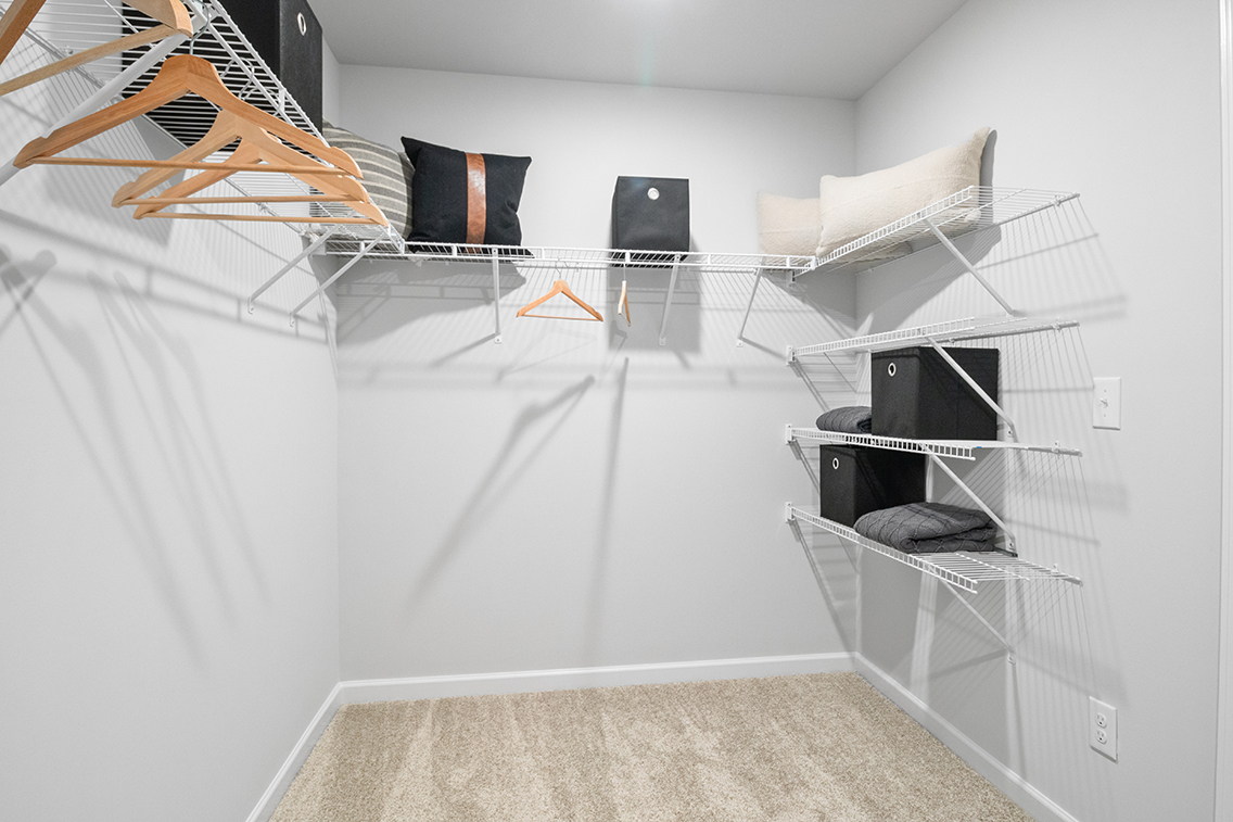 A room with a bed and a chair.