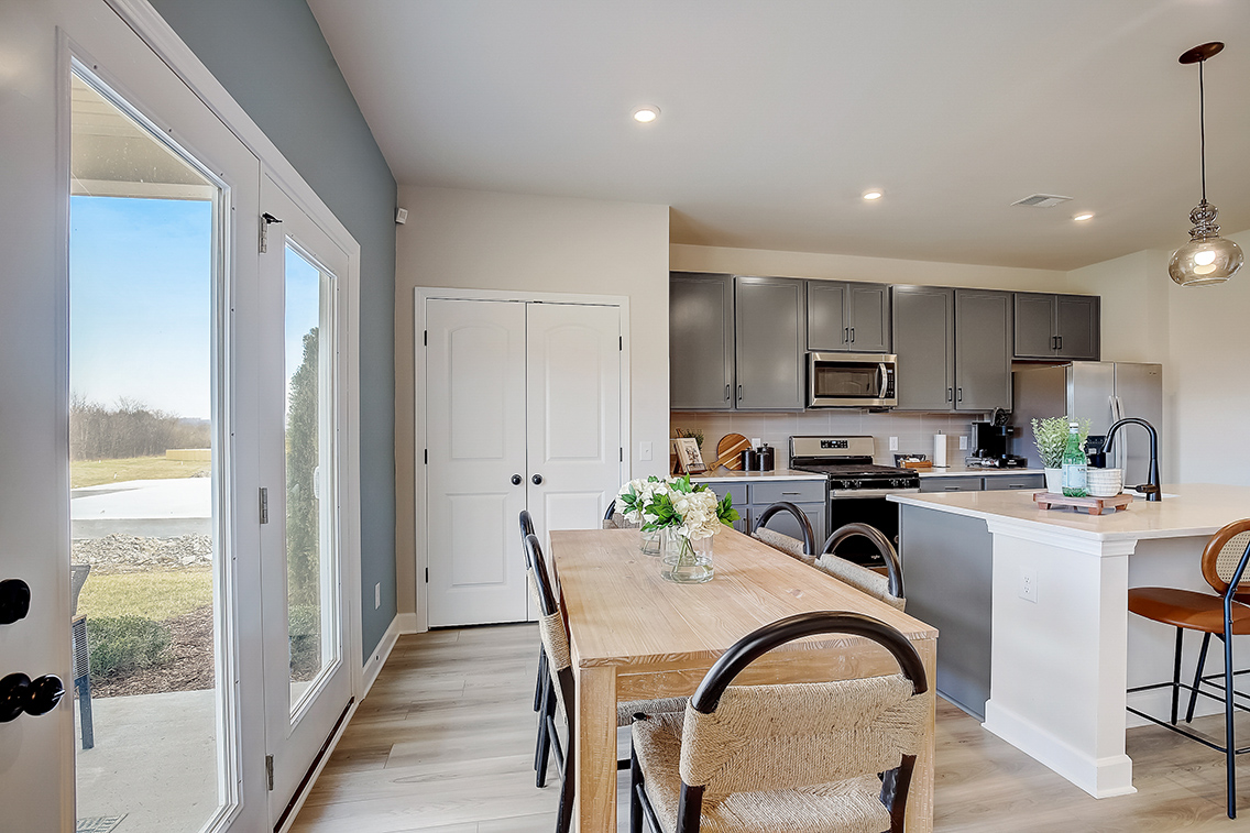 A kitchen with a dining table.