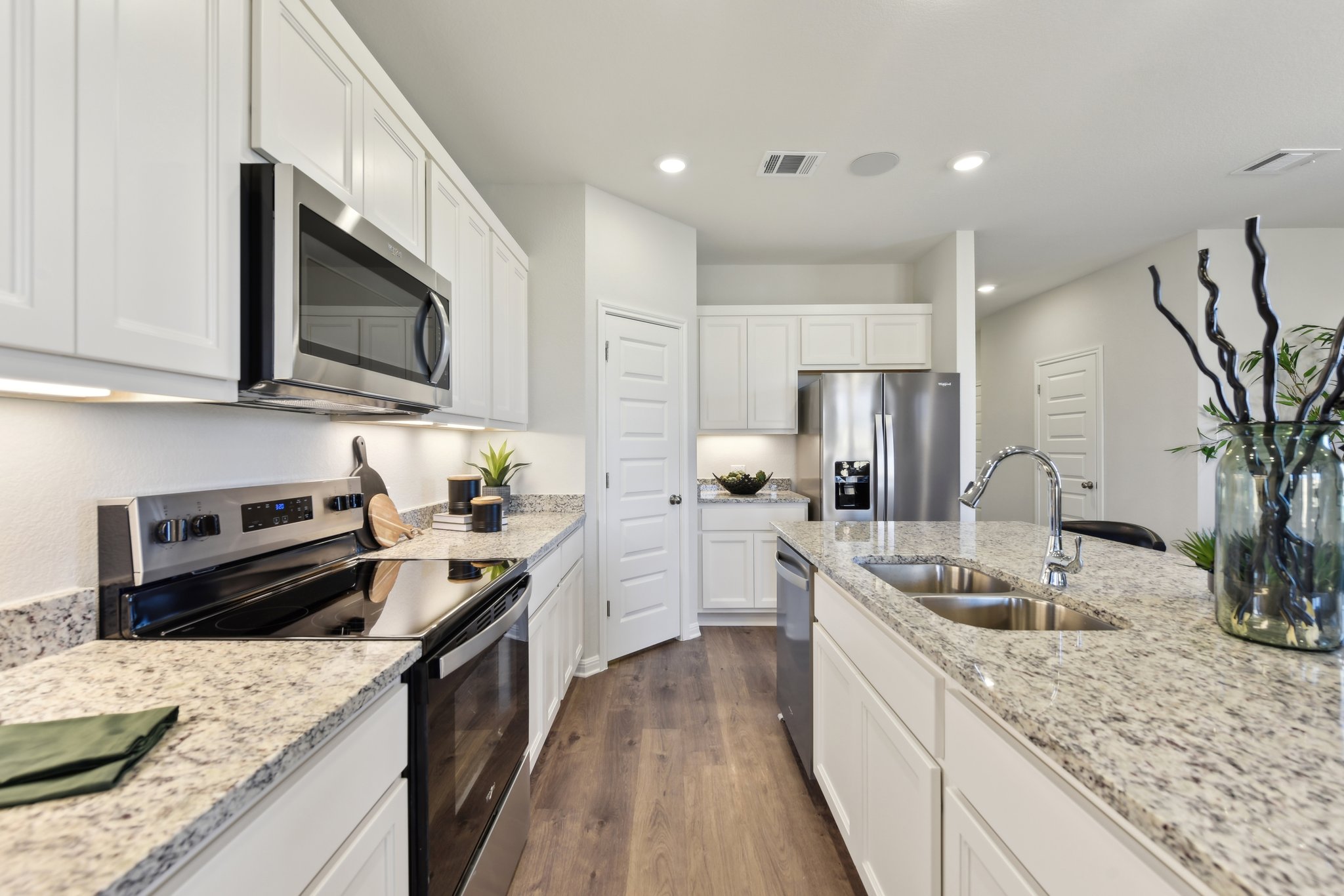 A kitchen with white cabinets.