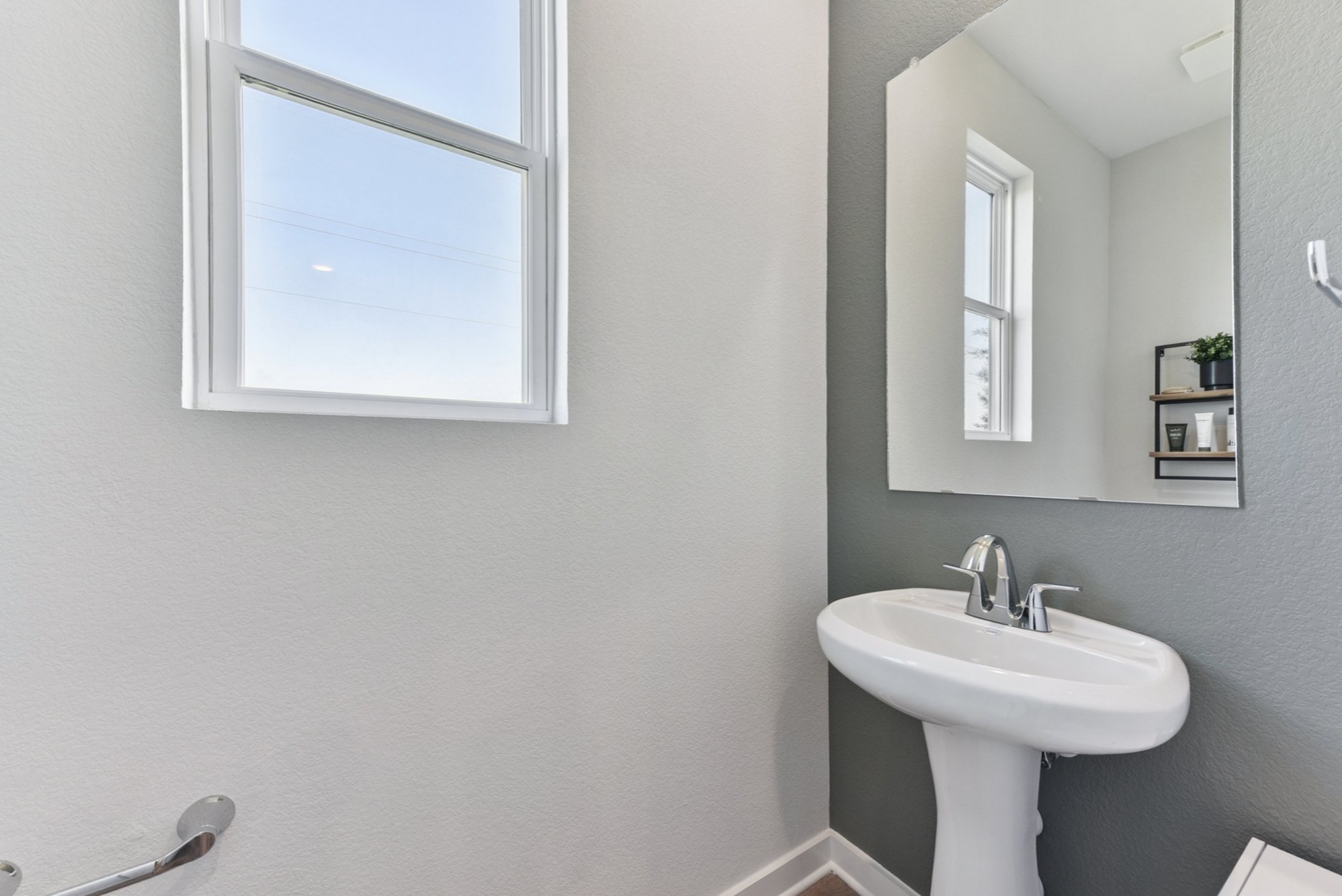 A bathroom with a sink and mirror.