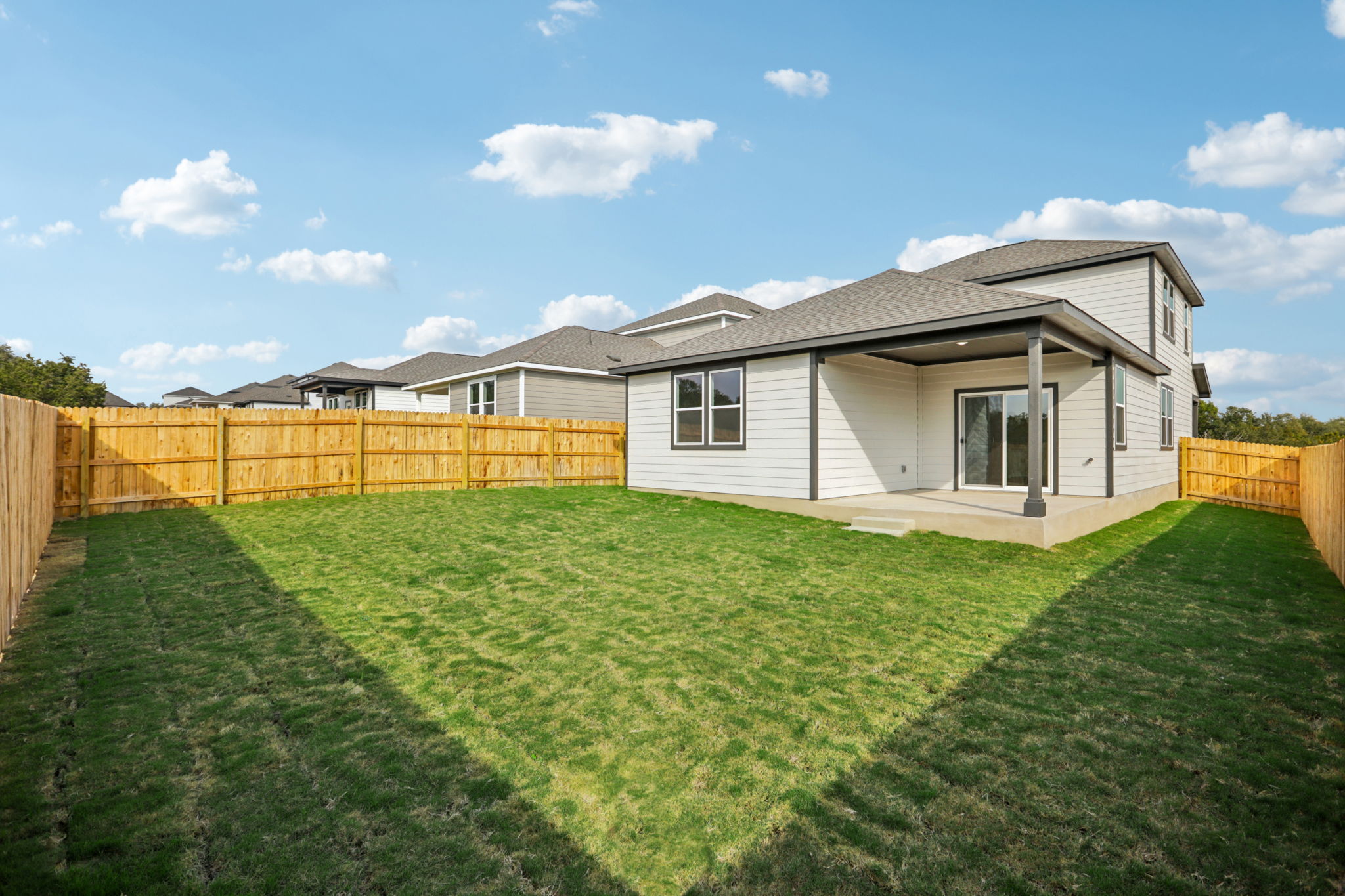 A house with a fence and grass.