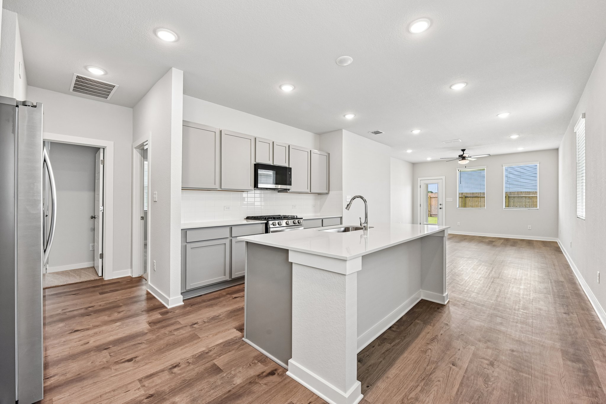 A kitchen with white cabinets.