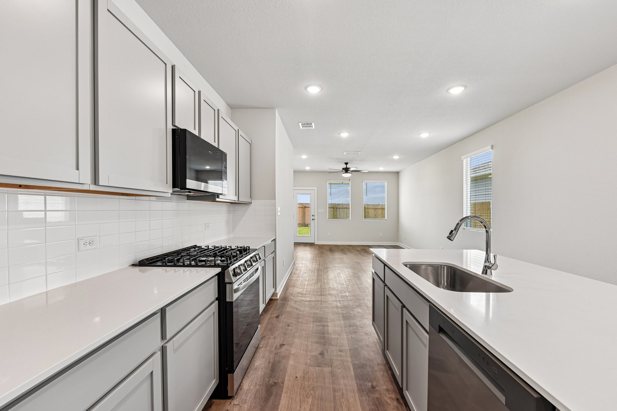 A kitchen with white cabinets.