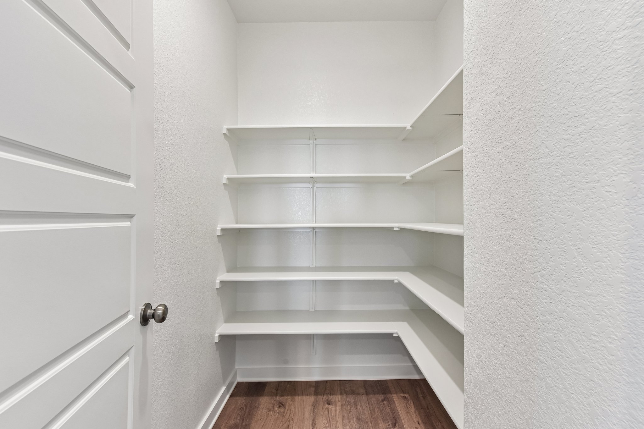 A white shelf in a room.
