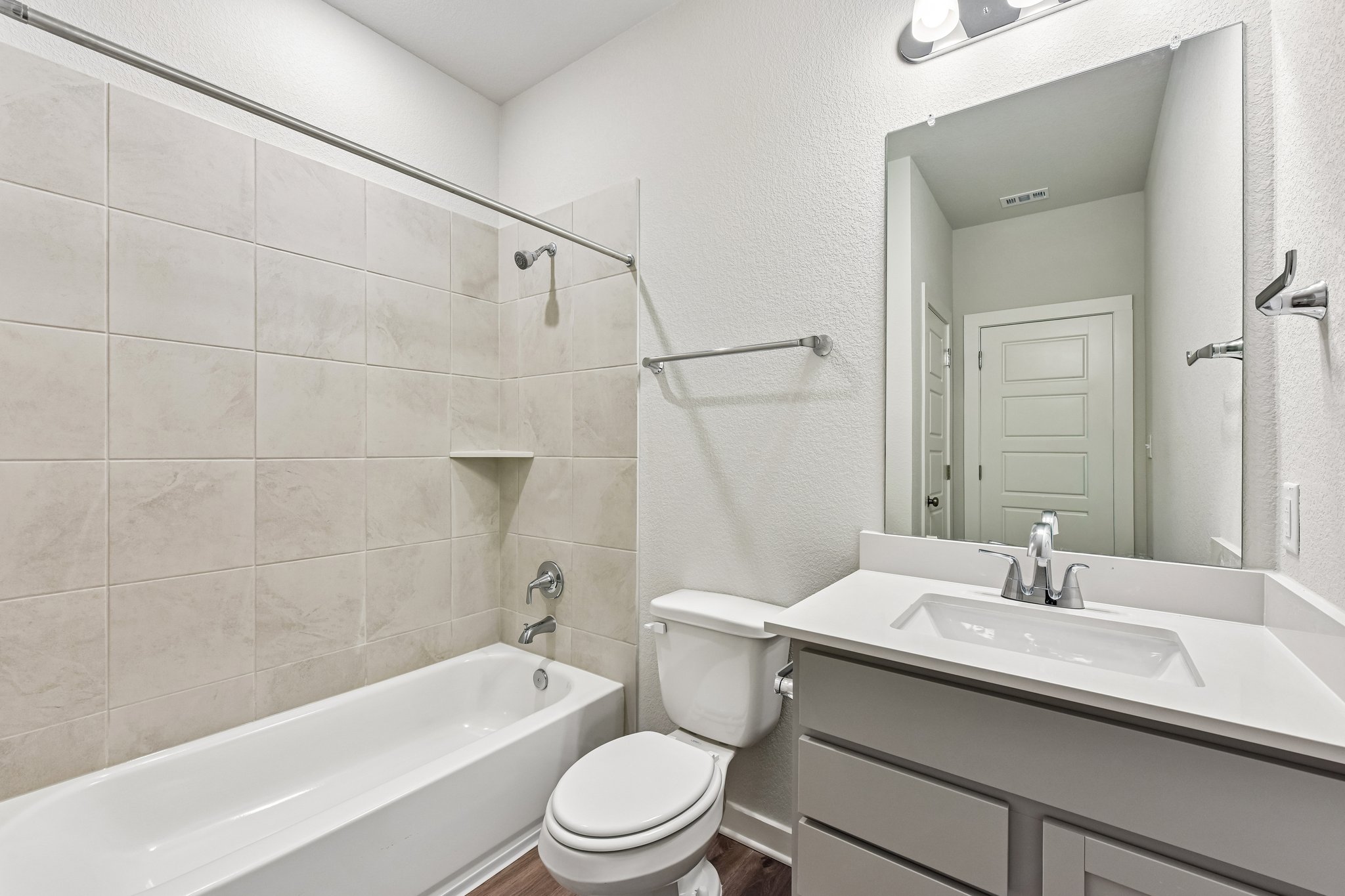 A bathroom with a tub sink and toilet.