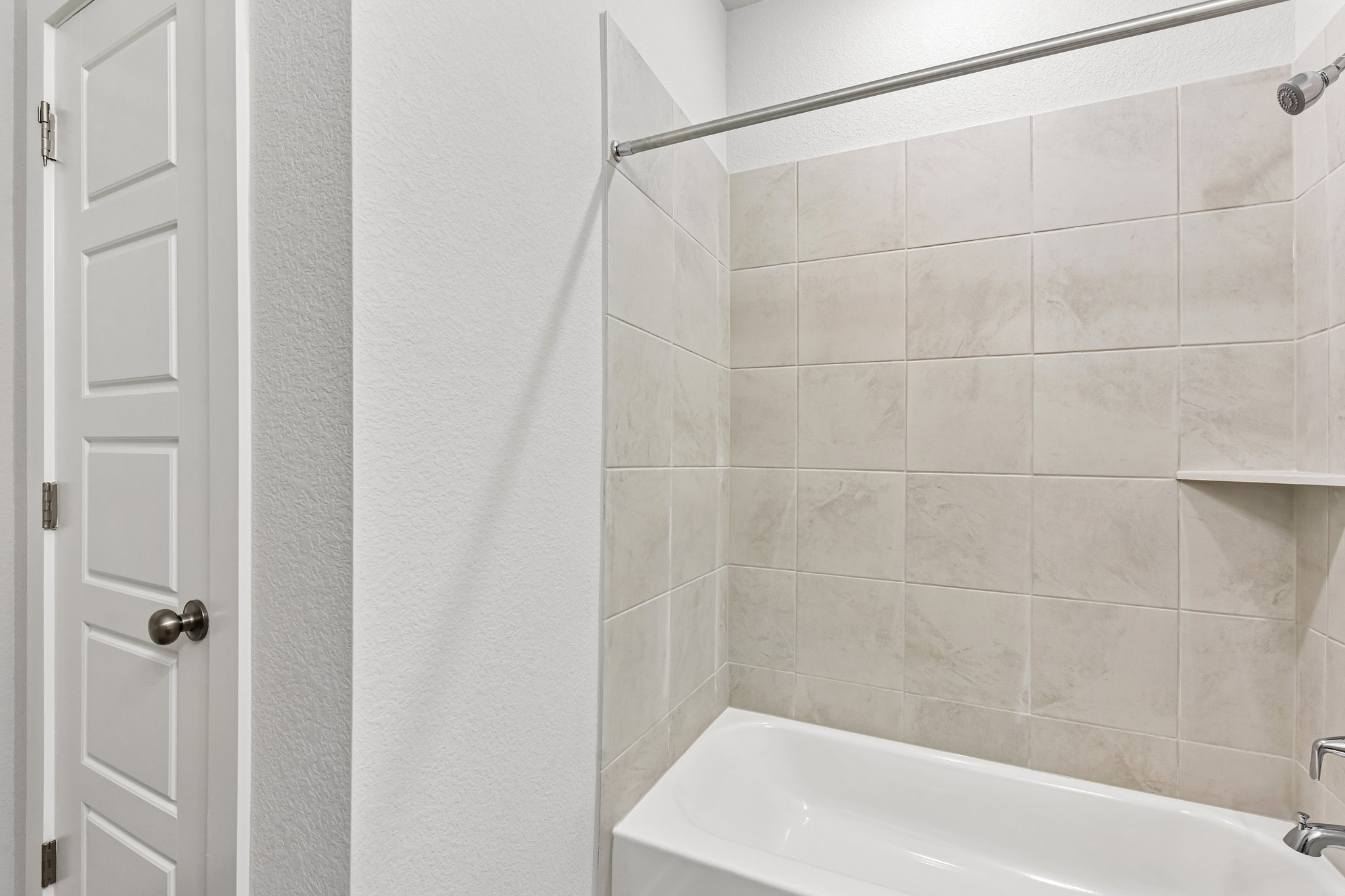 A white tiled bathroom.