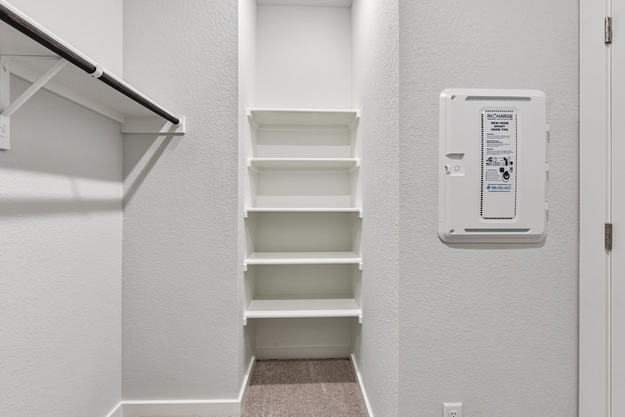 A white shelf with a white sign.