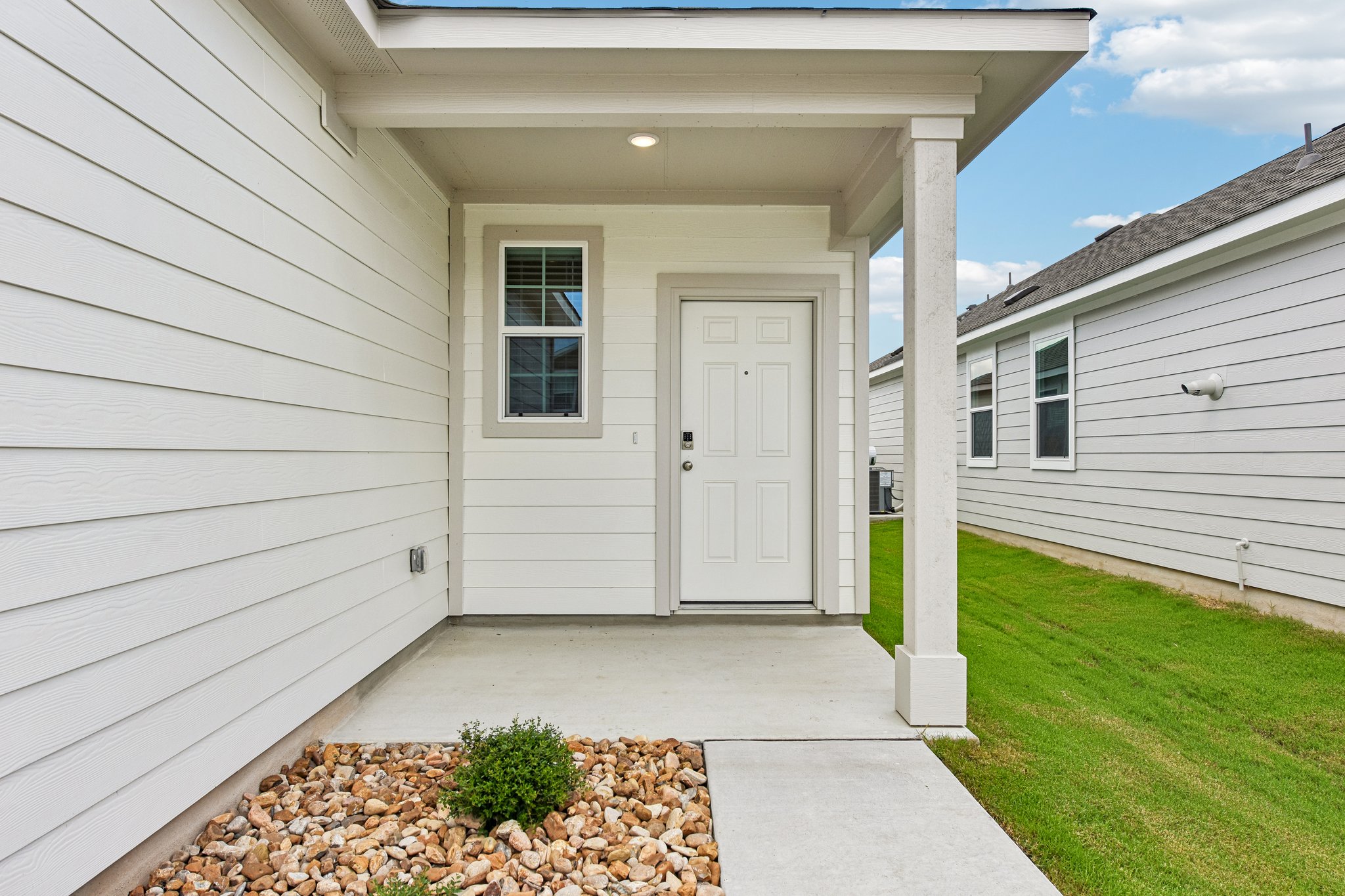 A house with a white door and a white garage.
