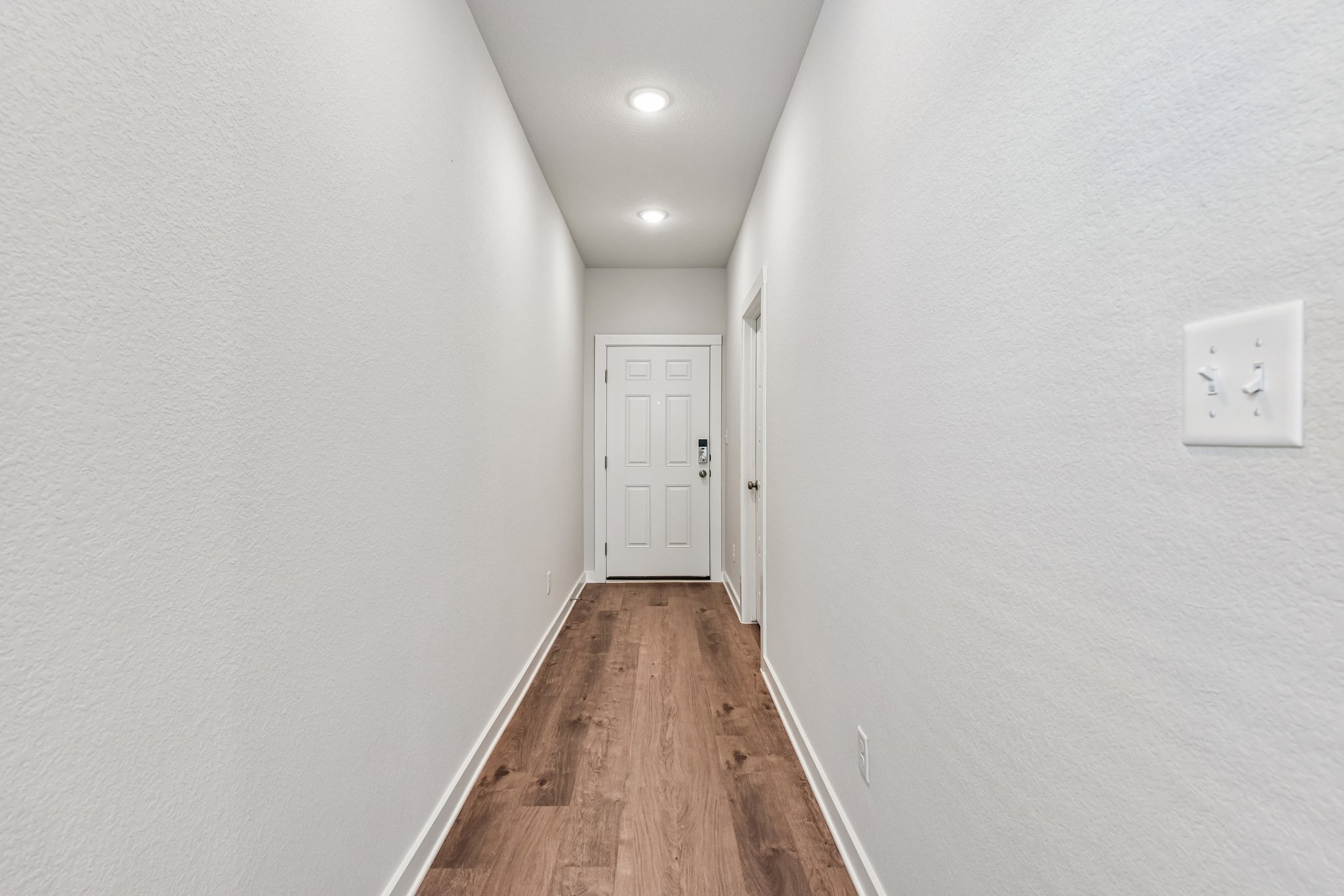 A hallway with white walls.