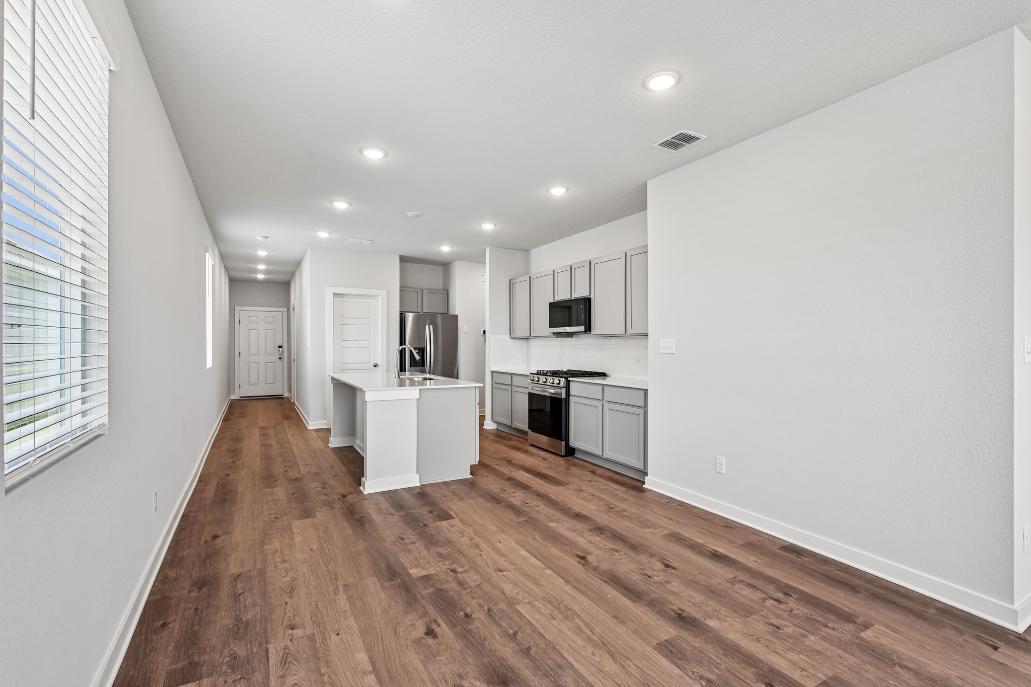 A kitchen with white cabinets.