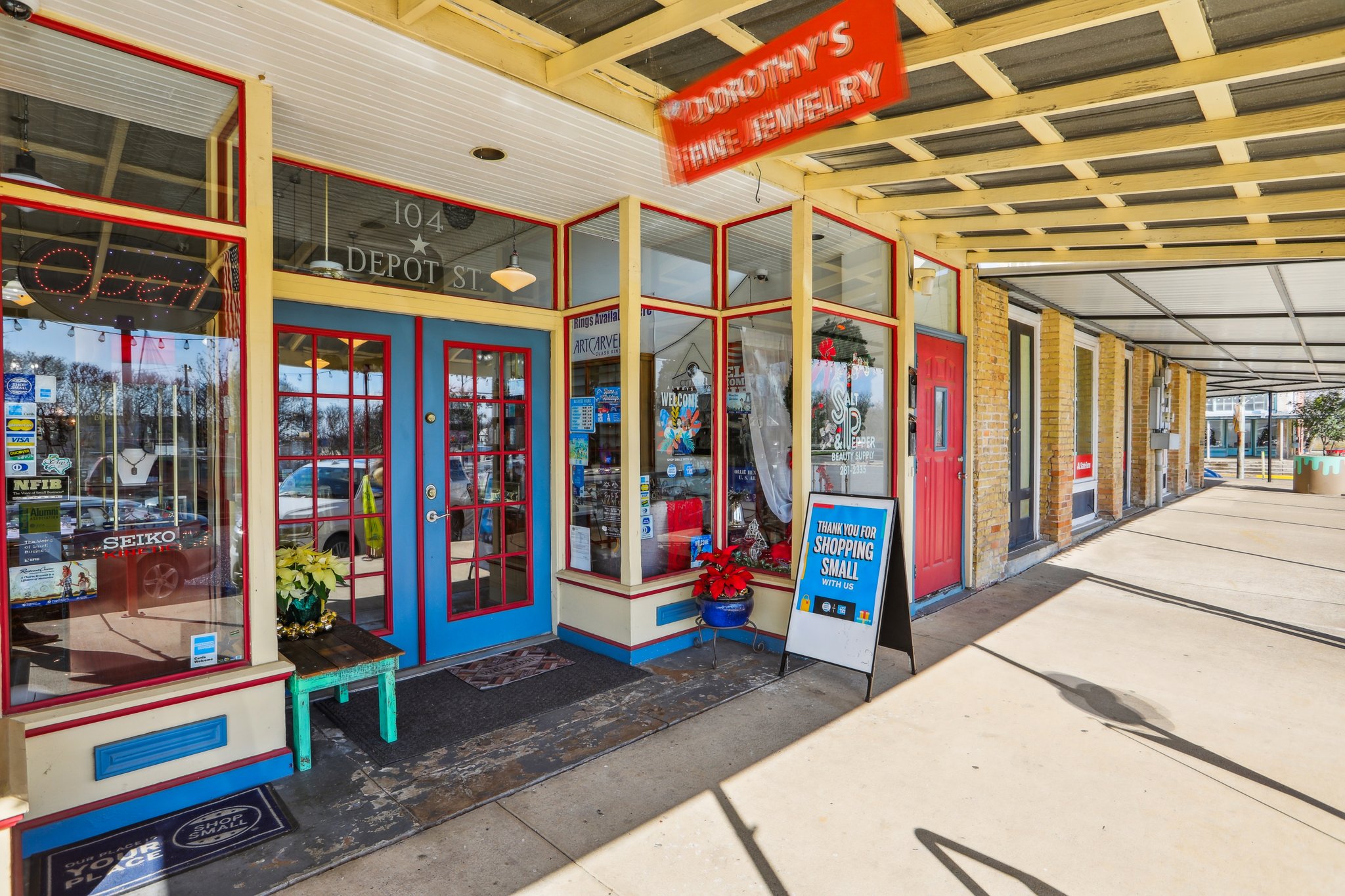 A store front with red doors.