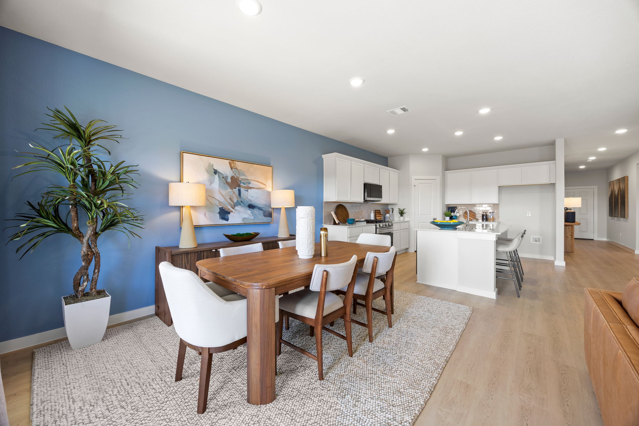 A dining room with a table and chairs.