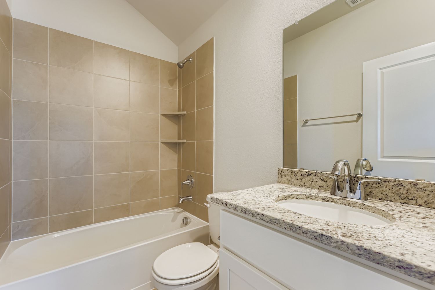 A bathroom with a marble countertop.