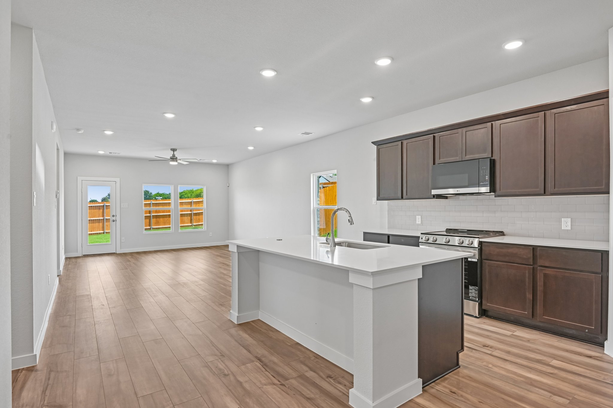 A kitchen with black cabinets.