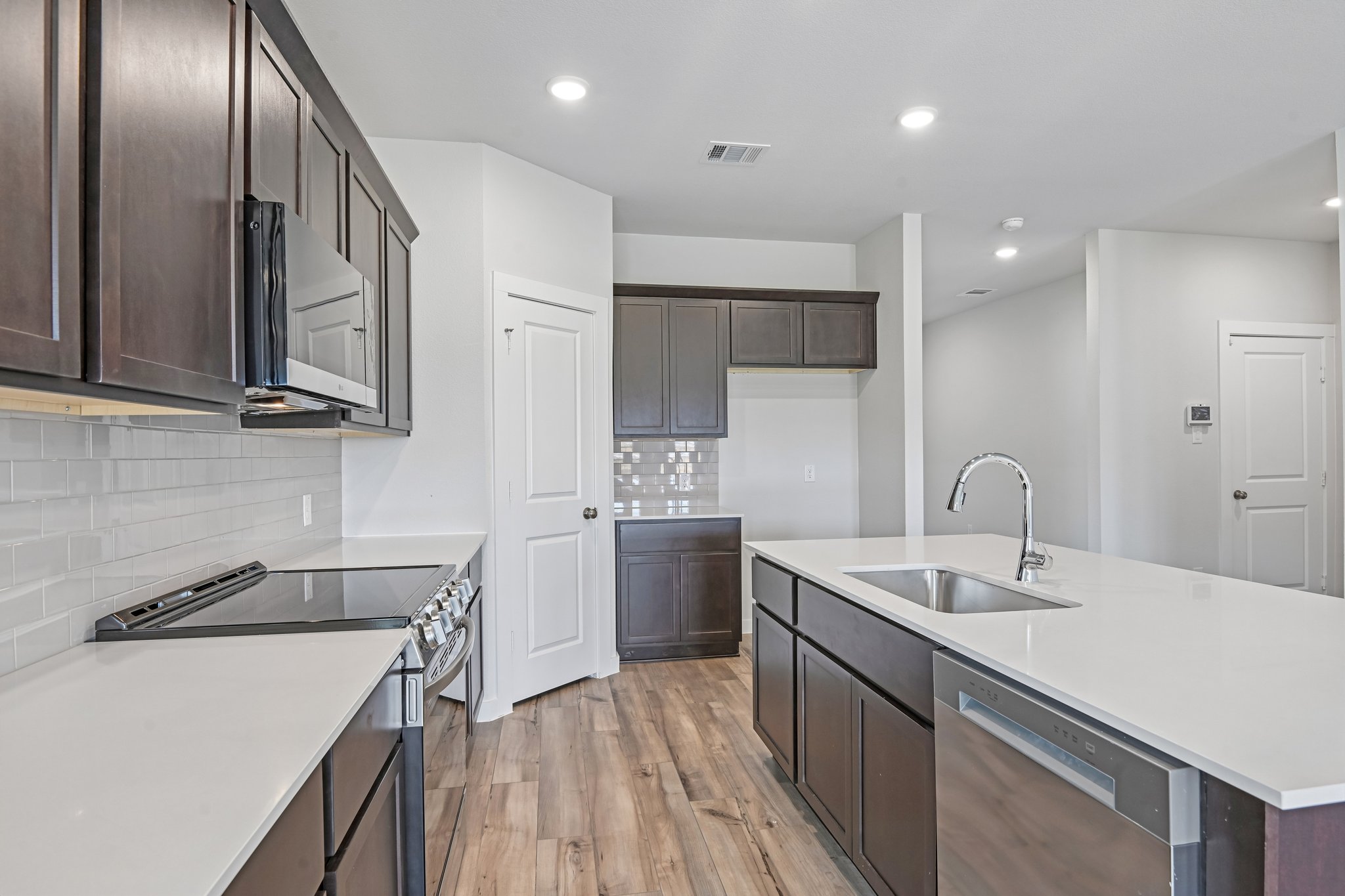 A kitchen with black cabinets.