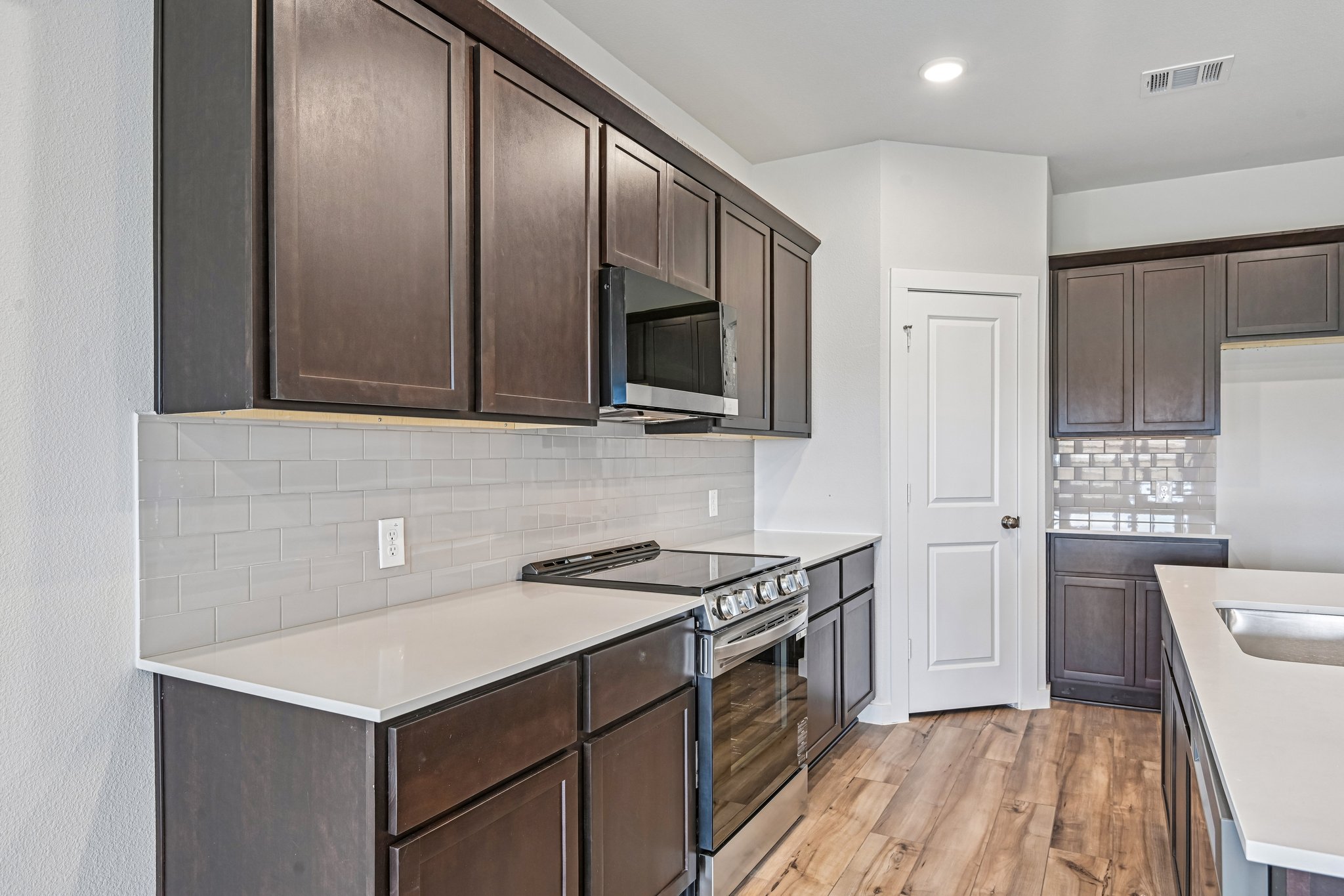 A kitchen with wooden cabinets.