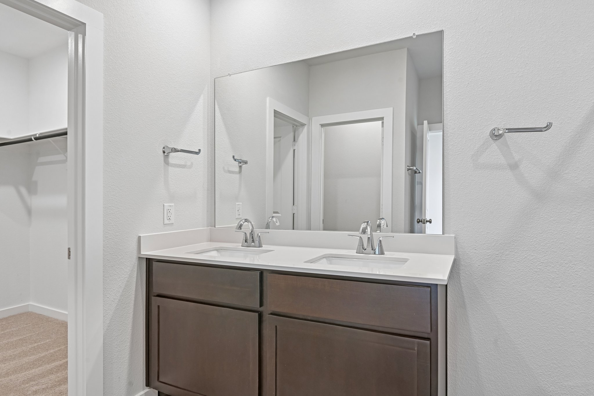 A bathroom with a large mirror.