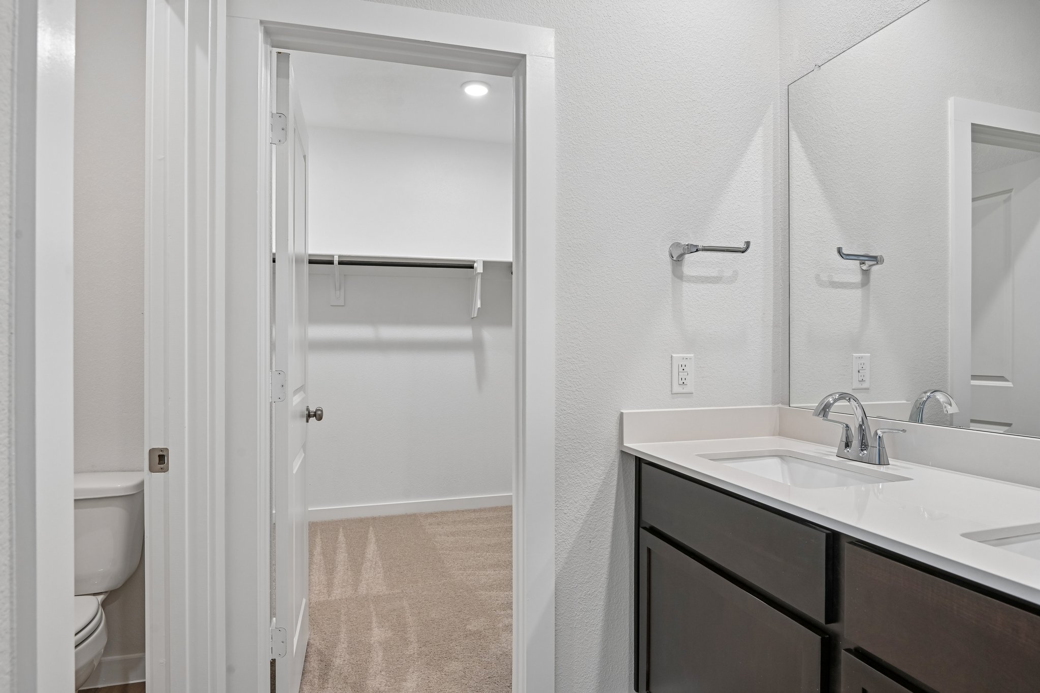 A bathroom with a shower and sink.
