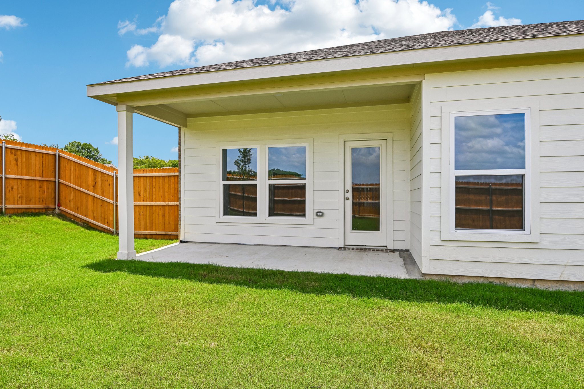 A house with a fence and grass.