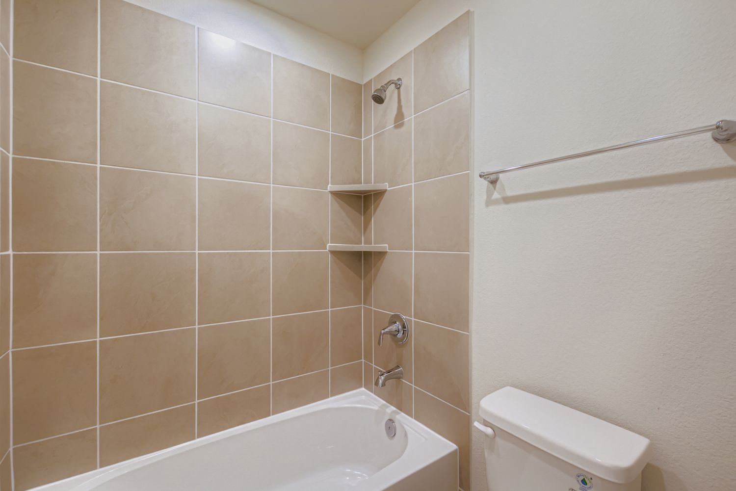 A bathroom with a bathtub and toilet.