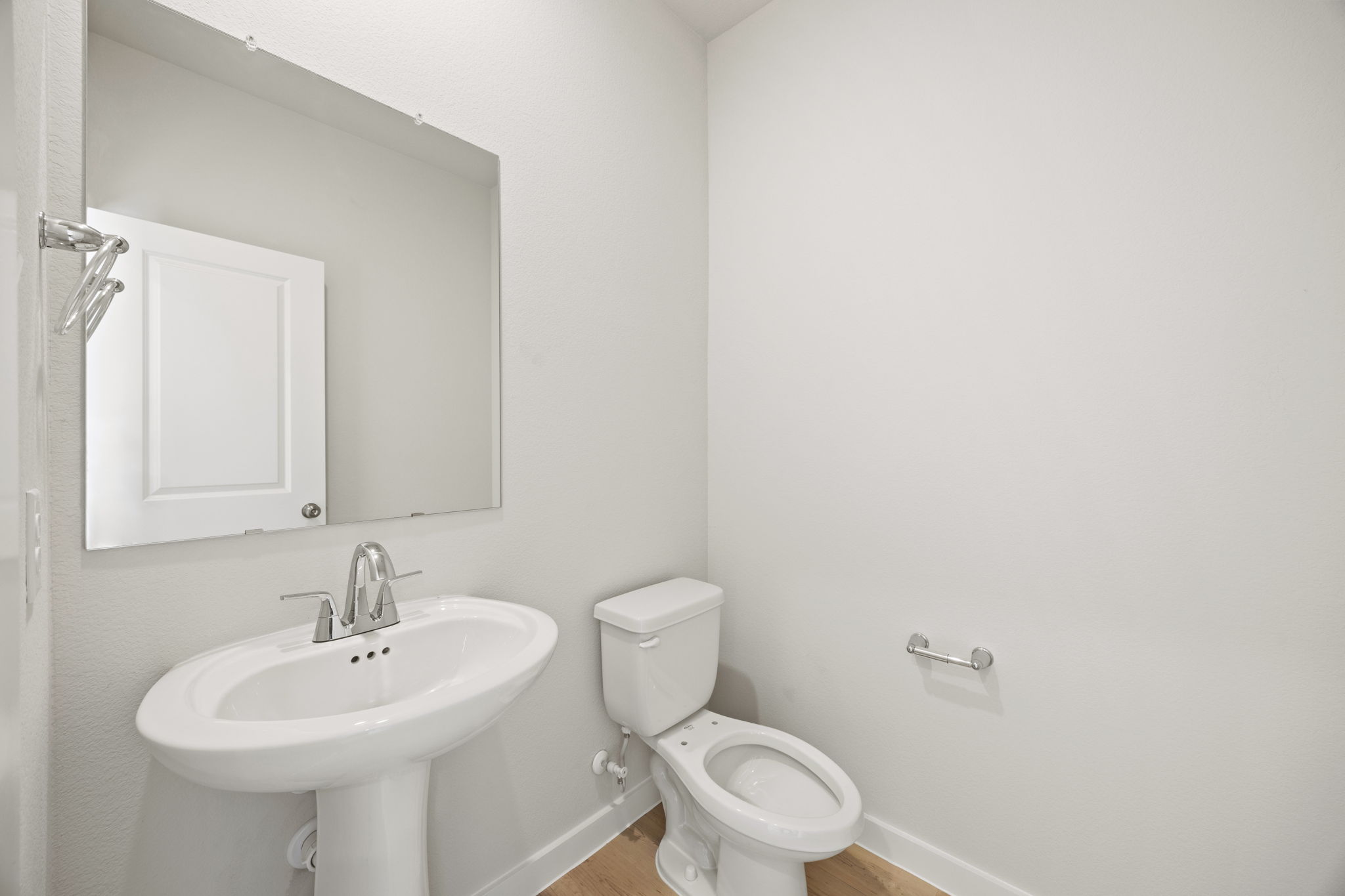 A bathroom with a toilet and sink.