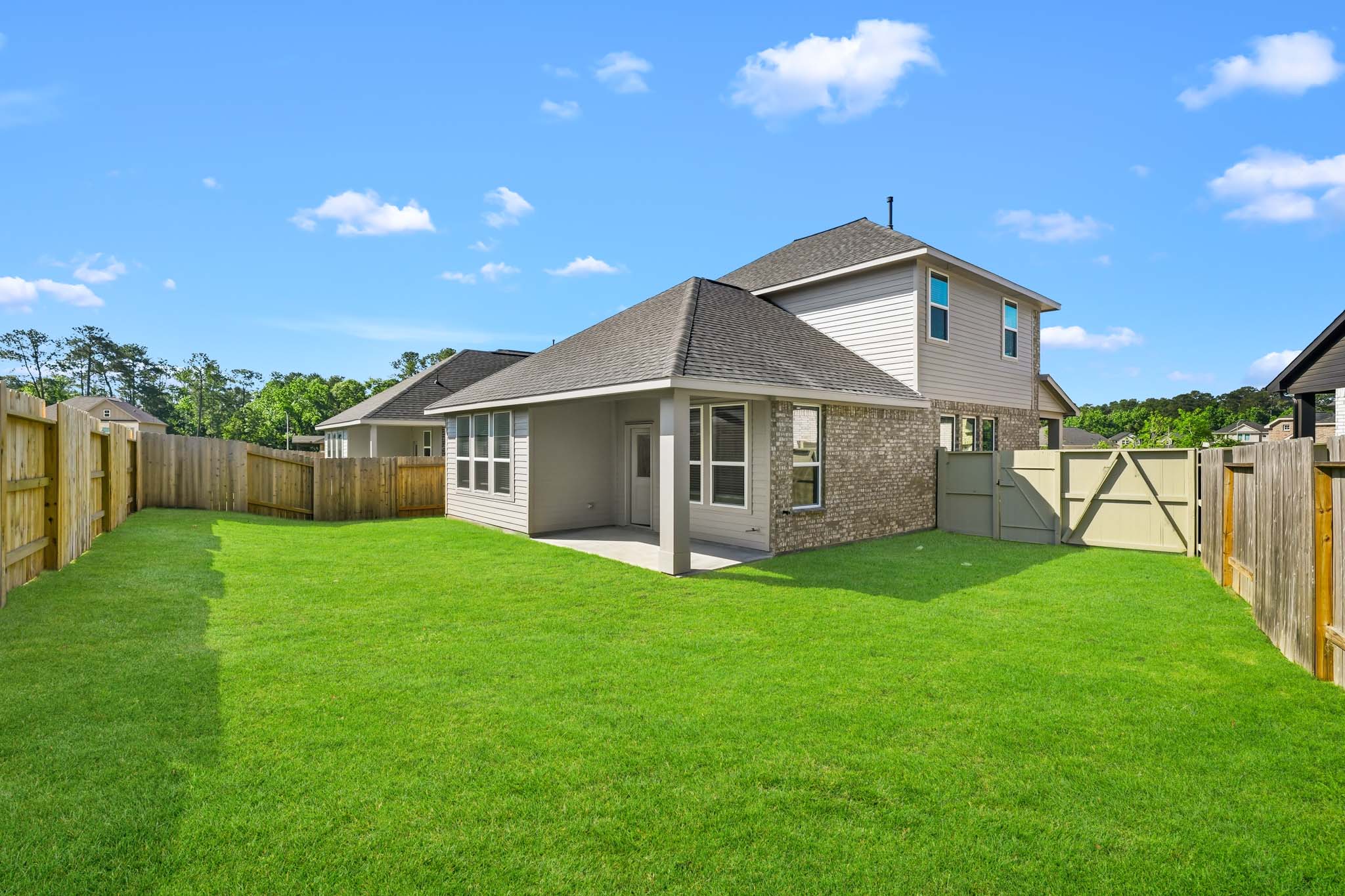 A house with a fence and grass.