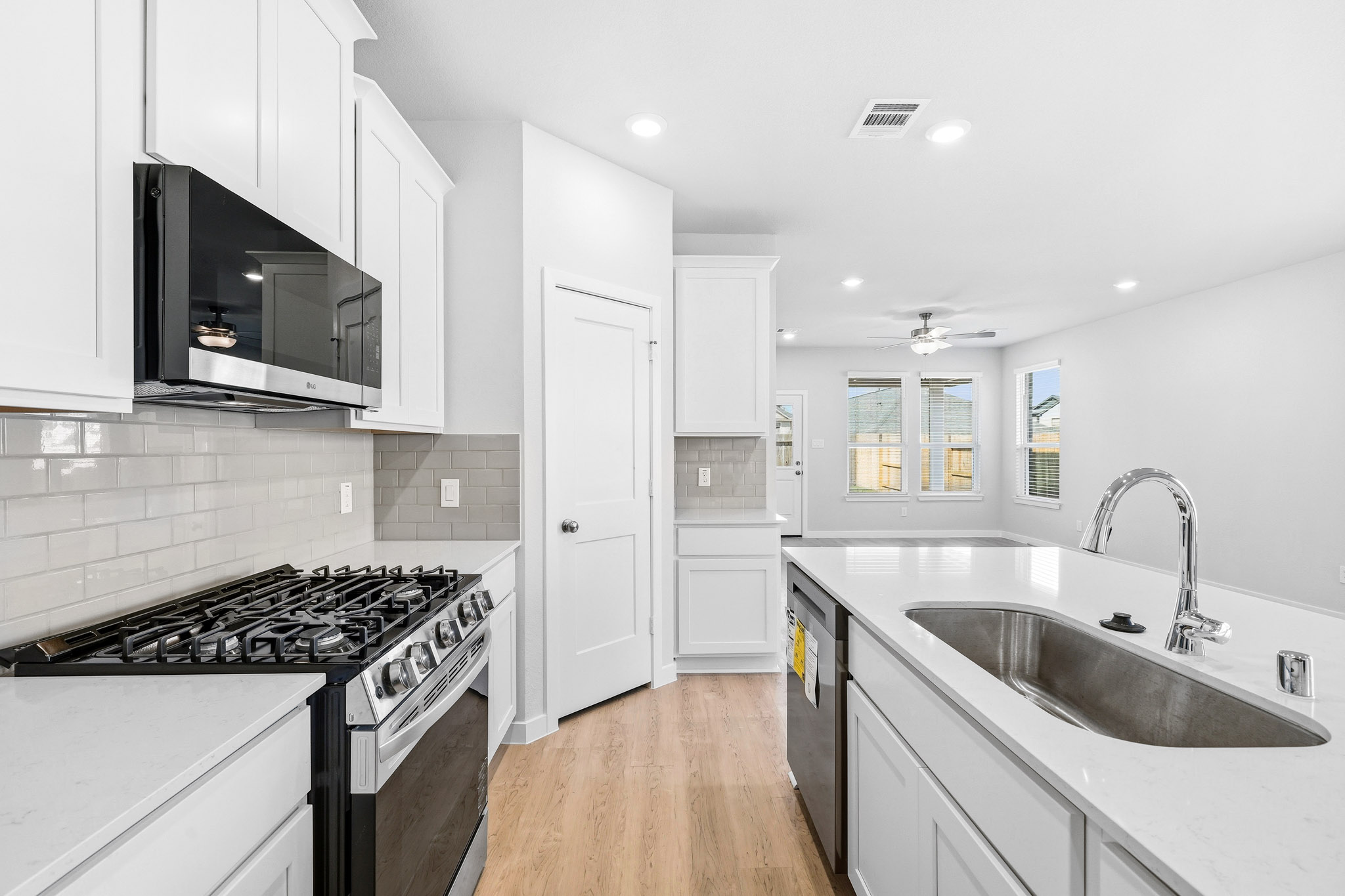 A kitchen with white cabinets.